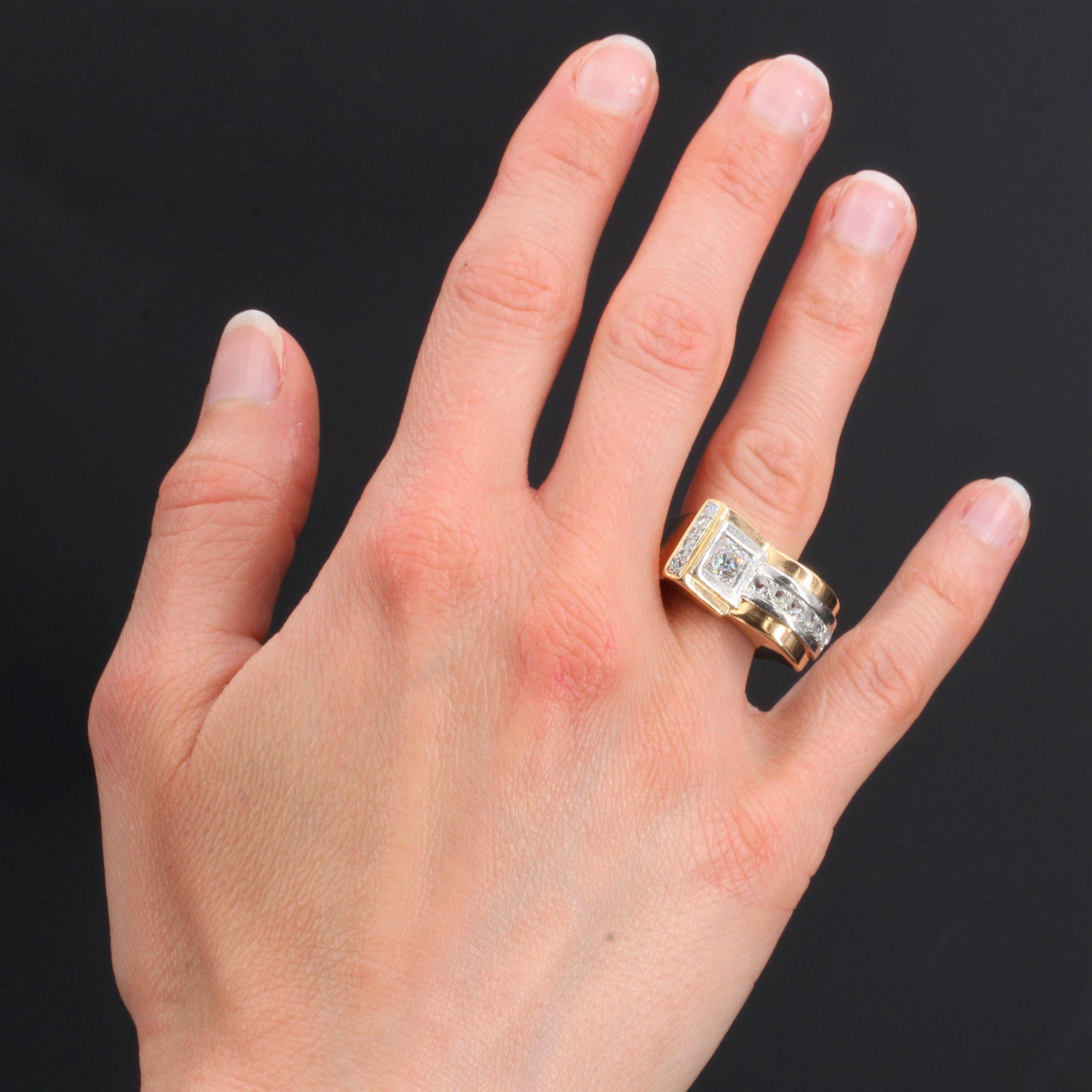 Ring in 18 karat rose gold, eagle head hallmark and platinum.
The asymmetrical setting of this magnificent tank ring is set on the top with an antique cushion-cut diamond on a geometrical decoration, a vertical line of rose-cut diamonds and a