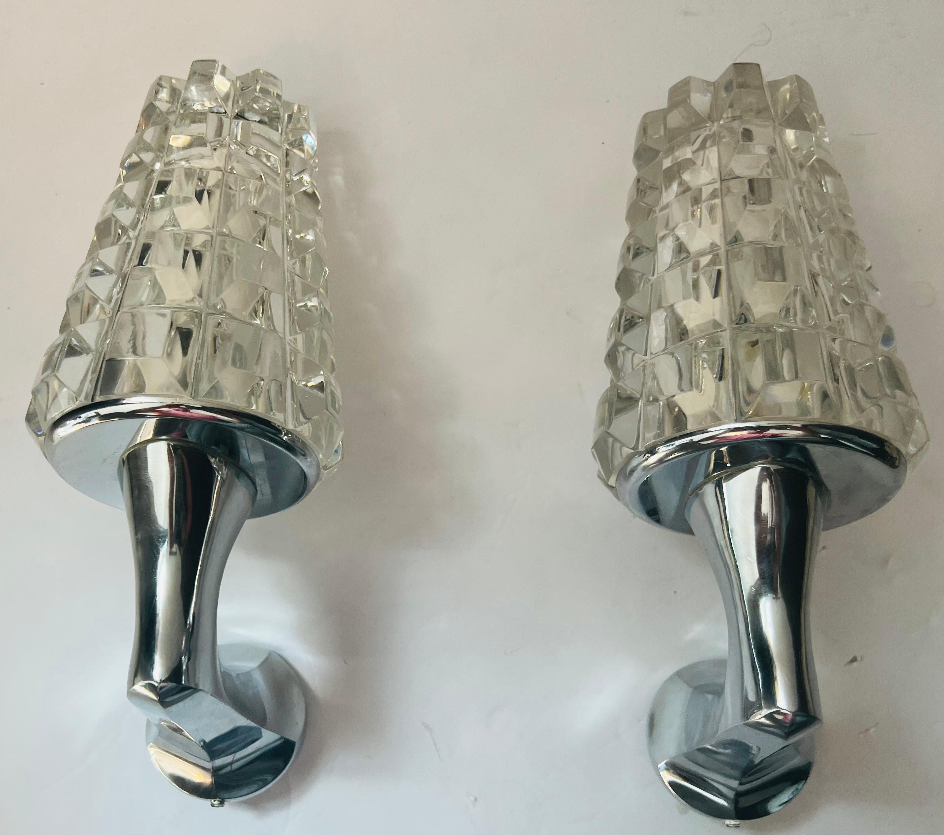 A beautiful rare pair of French polished nickel sconces with heavy thick faceted crystal shades. Newly rewired.