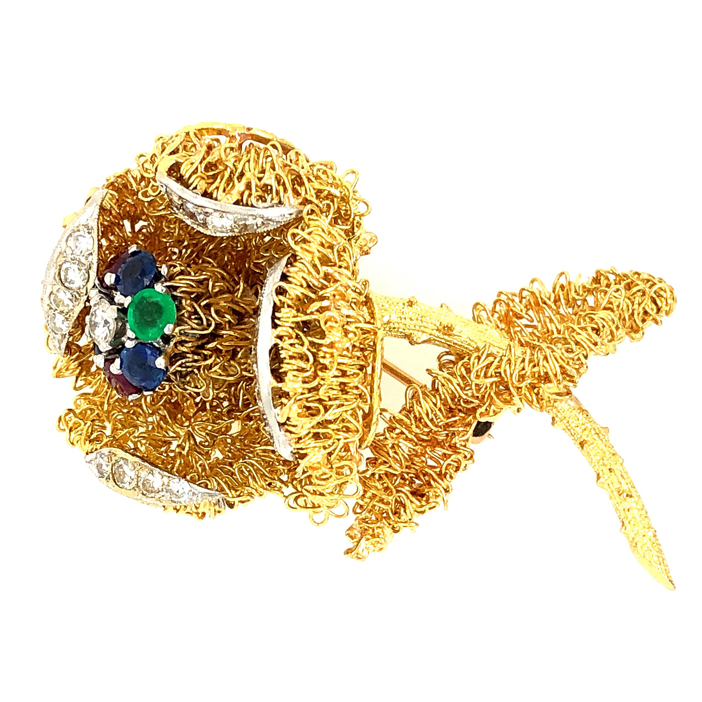 Offered here is a beautiful yellow gold flower brooch set with gems and diamonds. The brooch is estimated To be from the 1970’s. The inner part of the flower where the gems are set is designed to shake, really a cool piece. The brooch has 16