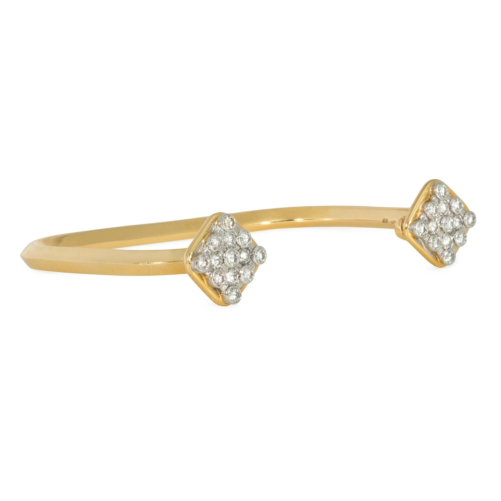 A 1970s gold geometric cuff bracelet with rhombus-shaped diamond-set terminals, in yellow and white 18k gold.  France.  Atw 1.00 ct.  Will fit up to 6 1/2