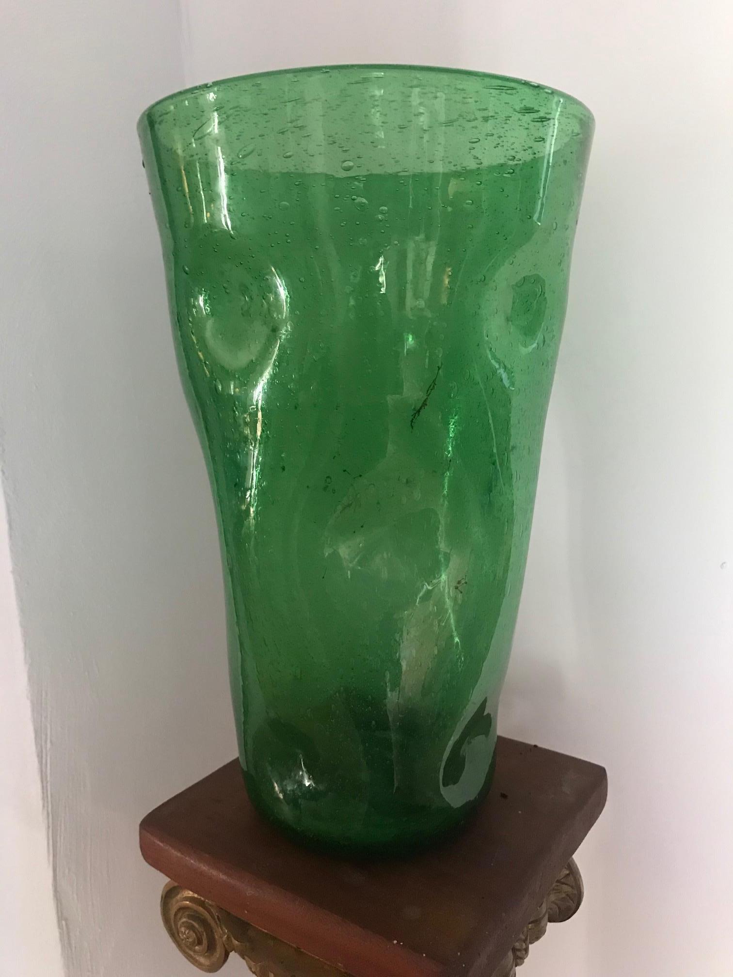 A tall hand blown French 1970s green glass vase. Perfect as an object for display or for using for tall flowers. Lovely form and color.