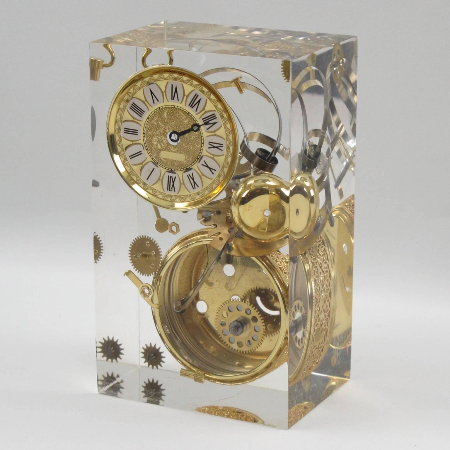 Unusual Lucite or resin sculpture with clock gears and parts embedded and floating in the cube, in the manner of French artist Arman. 
Clock not in working condition, of course!
Excellent vintage condition.

Measurements: 3.75 in. wide (9.5 cm)