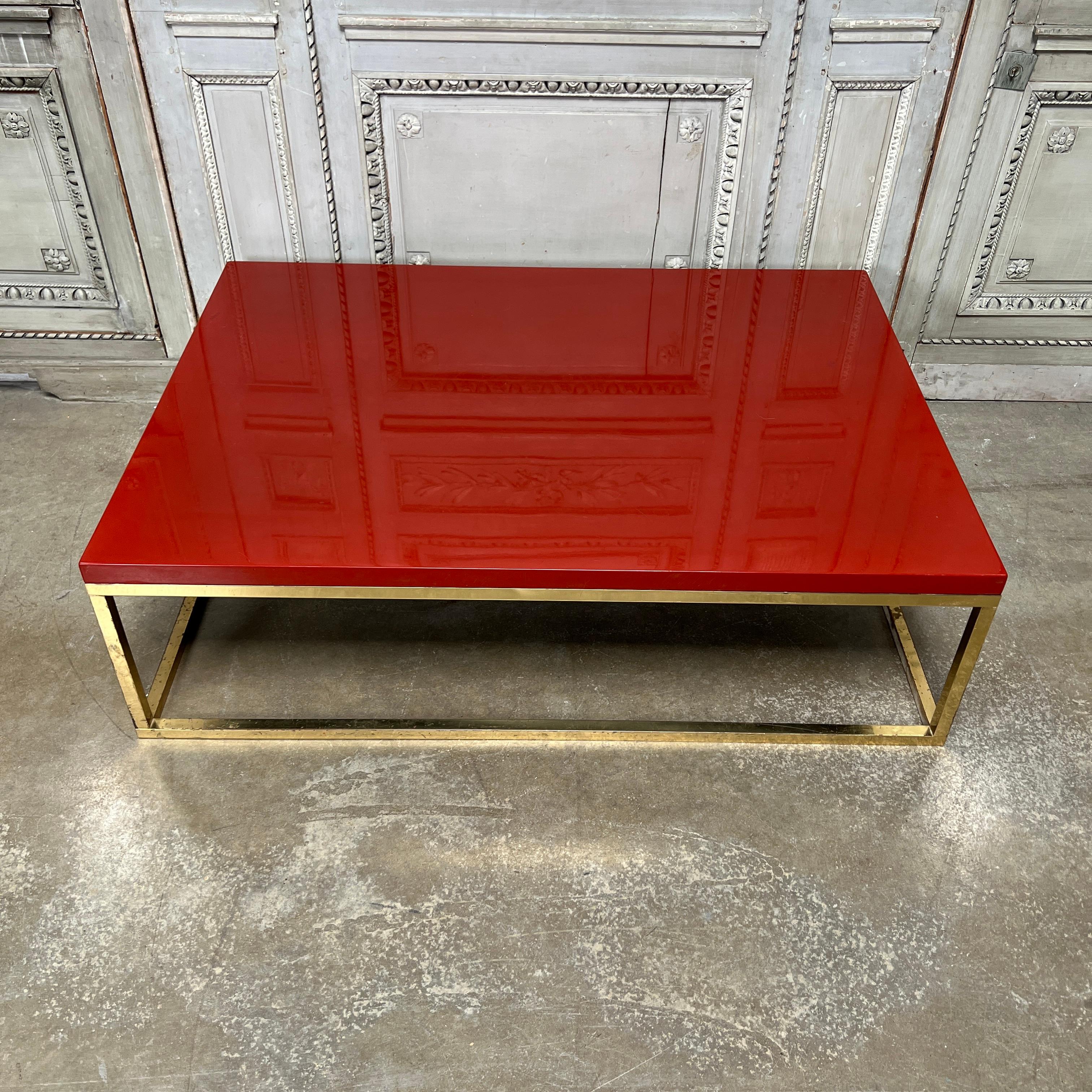 A French red lacquered and brass coffee - cocktail table. This table is a great scale and is very decorative and functional. It dates from the 1970s.