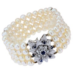 French 1970s Sapphire Diamonds 18 Karat White Gold Clasp 4 Rows Pearl Bracelet