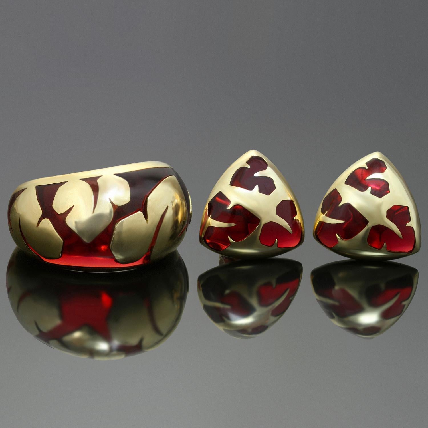 This fabulous ring and earrings set features a vibrant retro design of polished maroon glass and 18k yellow gold. Made in France circa 1970s. Measurements: 0.51
