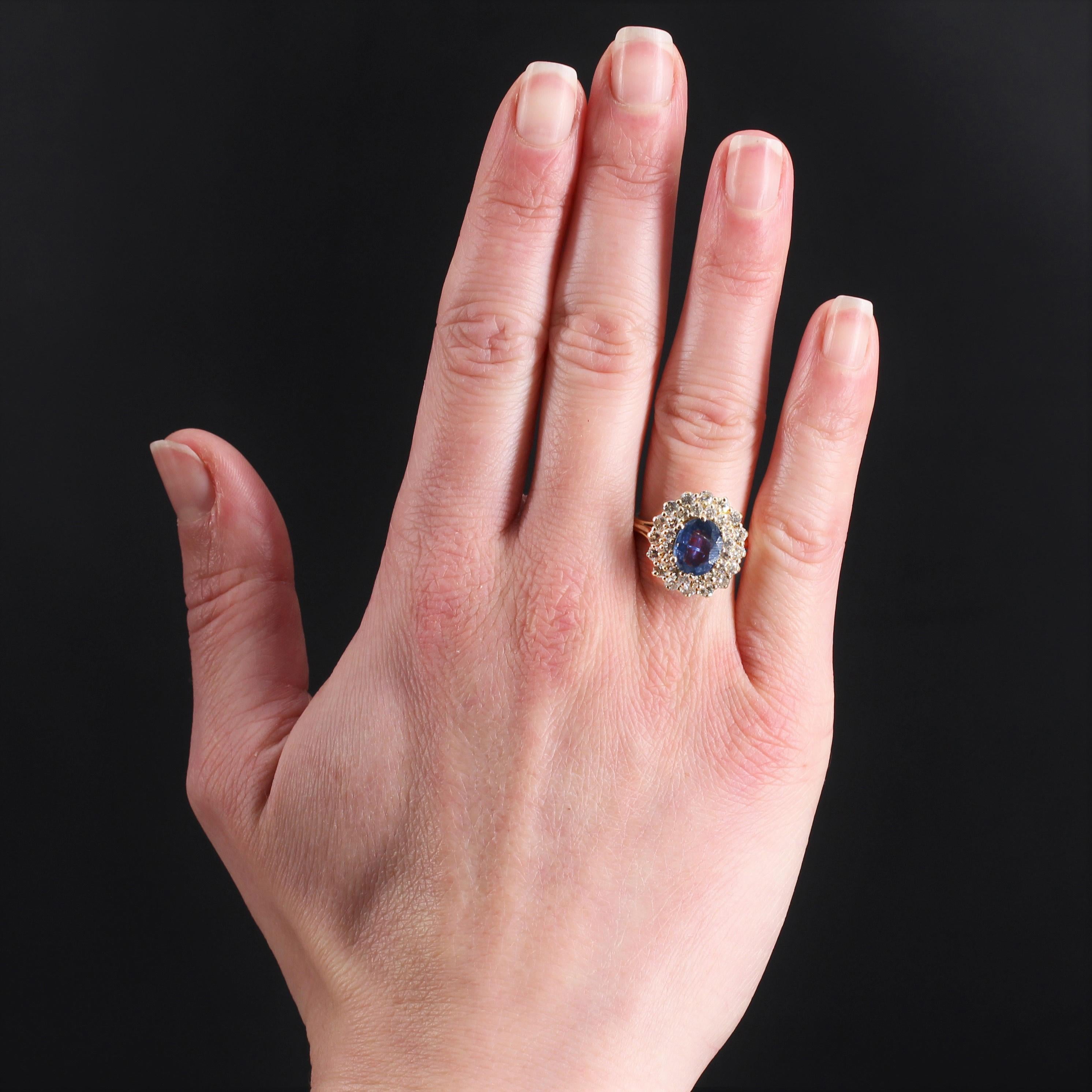 Ring in 18 karat yellow gold, own hallmark.
Retro ring, it is set with claws in the center of an oval sapphire in a double entourage of modern brilliant-cut diamonds, the setting and the ring are made of gold wire.
Weight of the sapphire : 2 carats