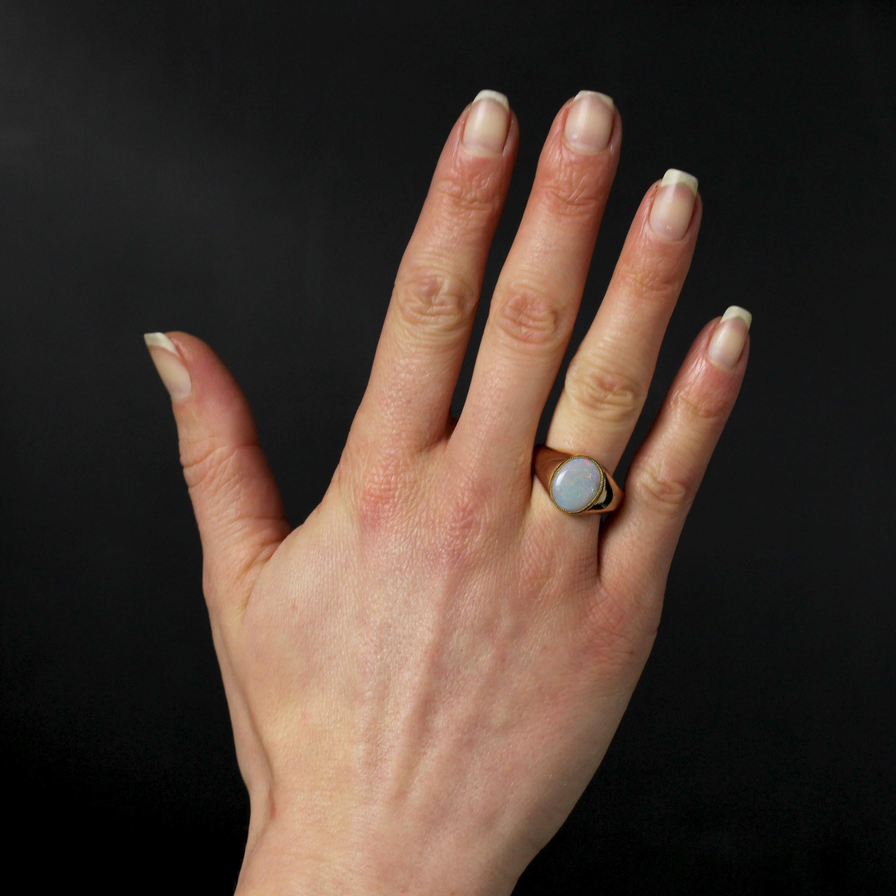 Ring in 18 karat rose gold, eagle head hallmark.
This vintage ring features a domed, tumbling band. A flat cabochon opal is set in millegrain on top.
Total weight of the opal : 1.20 carat approximately.
Height : 13.1 mm approximately width : 10.4 mm