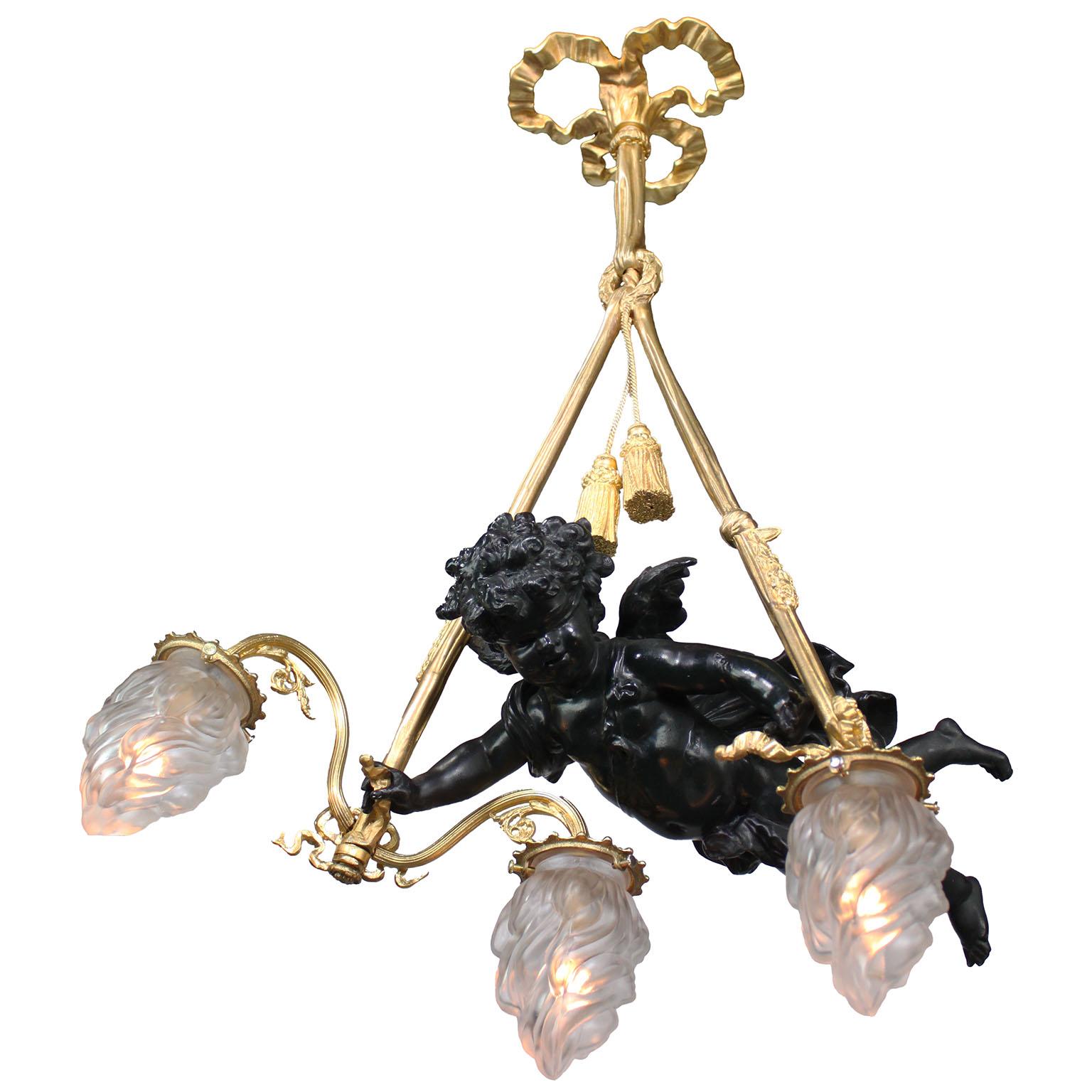 Pendentif chandelier à trois lumières en bronze doré et en métal doré à motif de chérubin, de style Belle Époque, du 19e au 20e siècle. La figure fantaisiste en bronze patiné noir d'un chérubin planant, symbolisant 