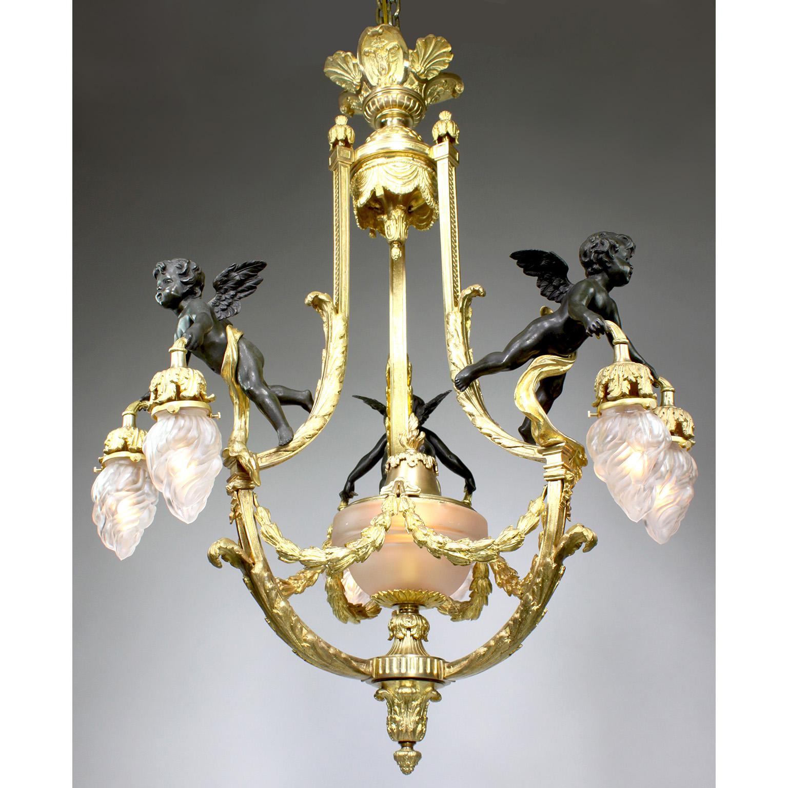A fine and Rare Whimsical French 19th/20th century Belle Époque Gilt-Bronze and Patinated Bronze Figural Seven-Light Chandelier. The with frosted glass flame shades centered with a frosted edged-glass urn with a gilt-bronze rim and acorn finial, all