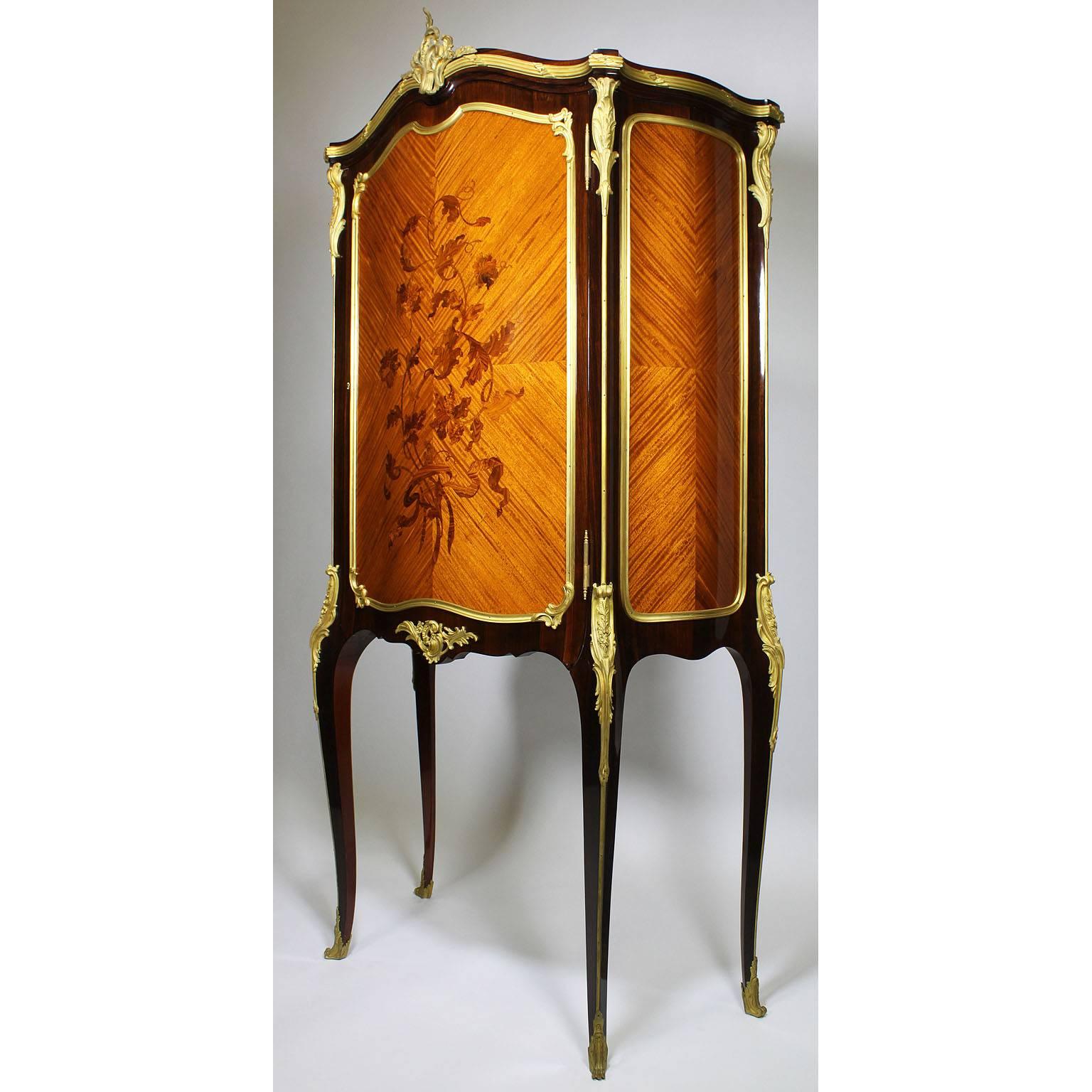 A fine French 19th-20th century Louis XV Style gilt bronze-mounted, Mahogany and Tulipwood Marquetry Side Cabinet/Secretaire in the style of François Linke (1855-1946). The slender serpentine mahogany body with a single paneled front door with a