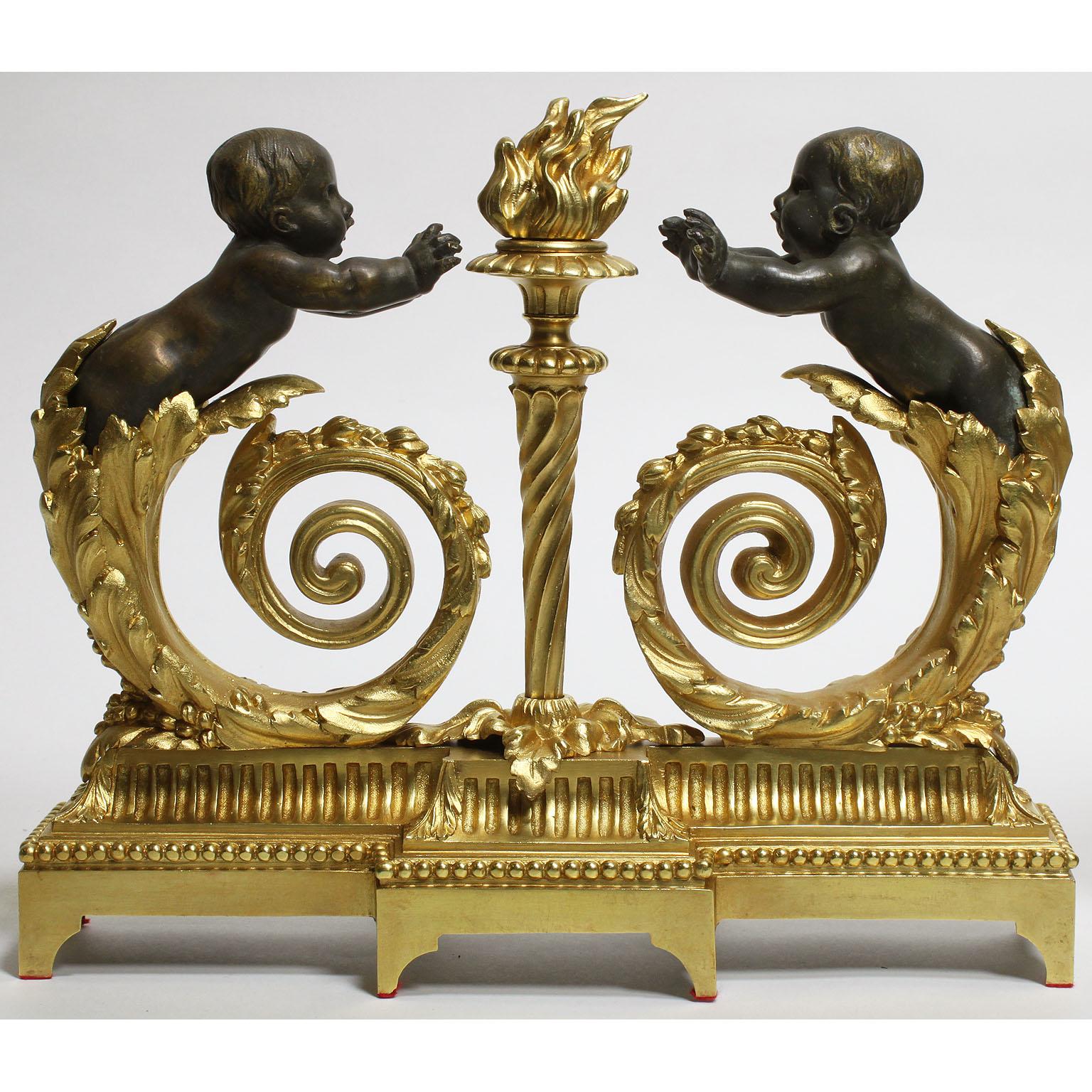A fine pair of French 19th-20th century Louis XV style gilt and patinated bronze figural chenets. Each cast as two patinated figures of amorini (Putti) growing out of leafy volute vine stems warming their hands on the centre flambeau, raised on a