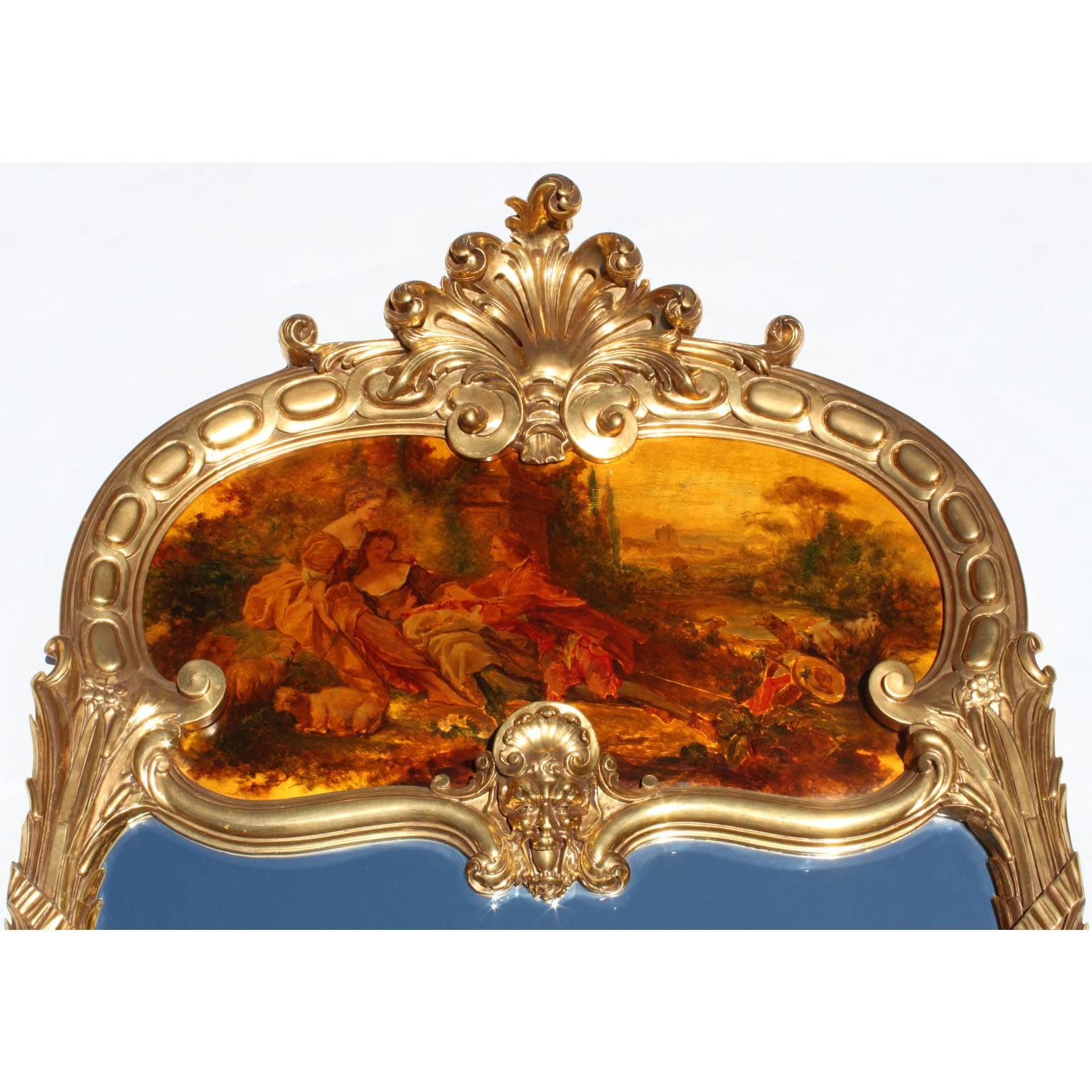 A fine French 19th-20th century Louis XV style giltwood carved figural trumeau mirror. The elongated frame crowned with a carved floral shell above an allegorical mask of a satyr and centred with an oil on panel painting depicting an outdoor