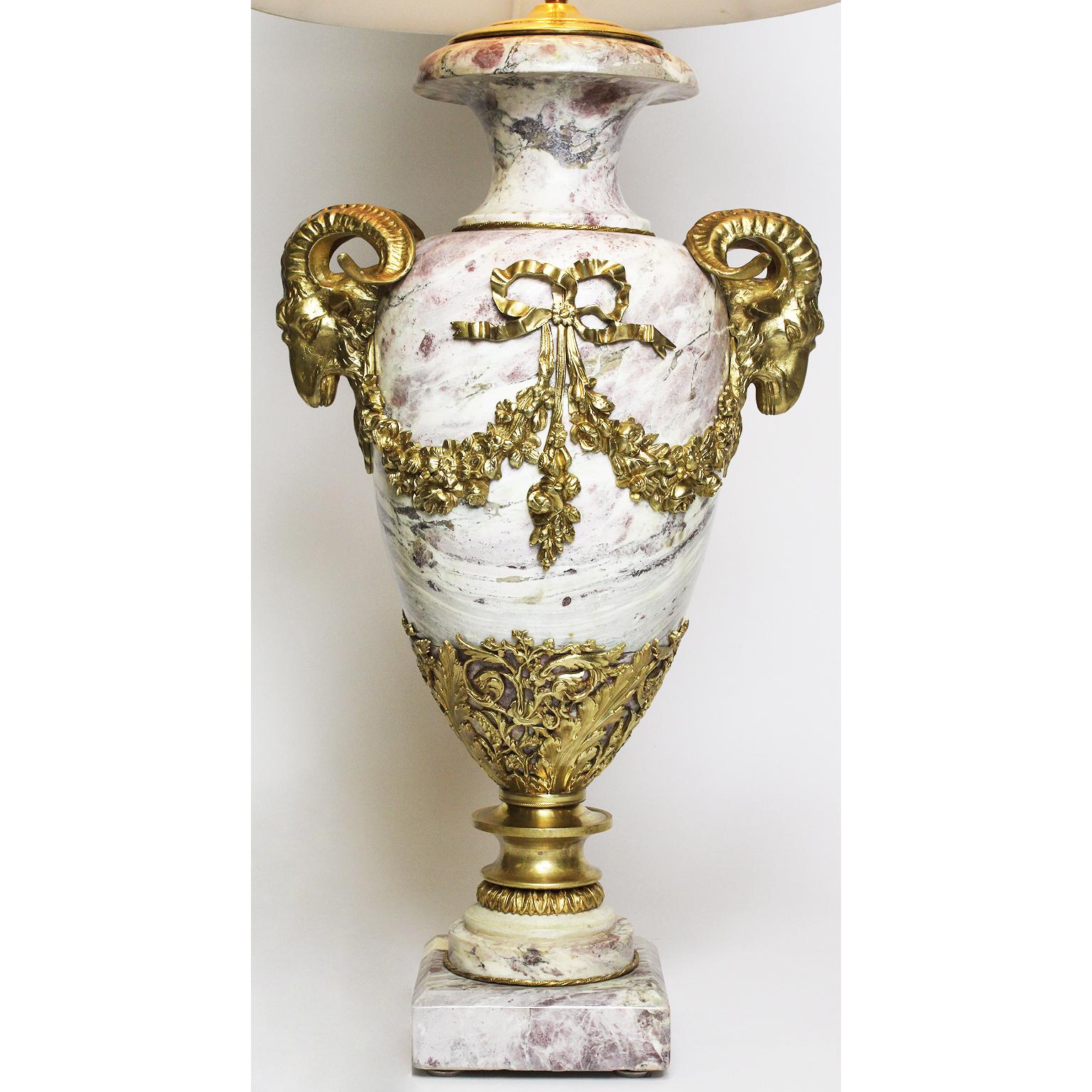 A fine French 19th-20th century Louis XV style Brêche violette marble and gilt bronze-mounted figural urn (Now a lamp). The ovoid marble body surmounted with twin gilt bronze figures of ram heads flanked by floral wreaths with tied ribbons, the base