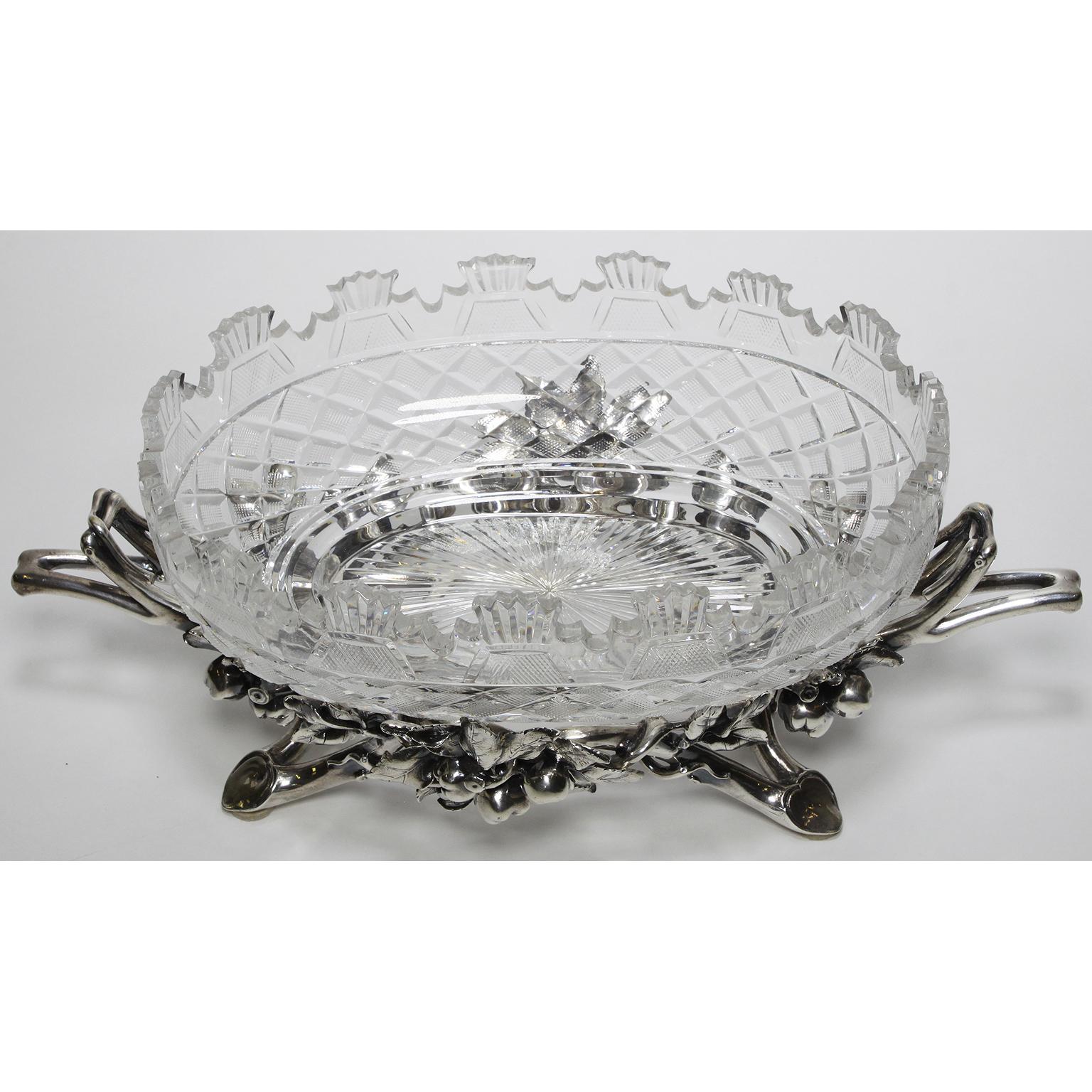A fine French 19th-20th century Louis XV style silvered centrepiece by Christofle & Cie. with an ovoid molded cut-glass centre-dish (later) on a pomegranate branch-form foot, the underside stamped: CHRISTOFLE and 1147156, Paris, circa 1900.

Charles