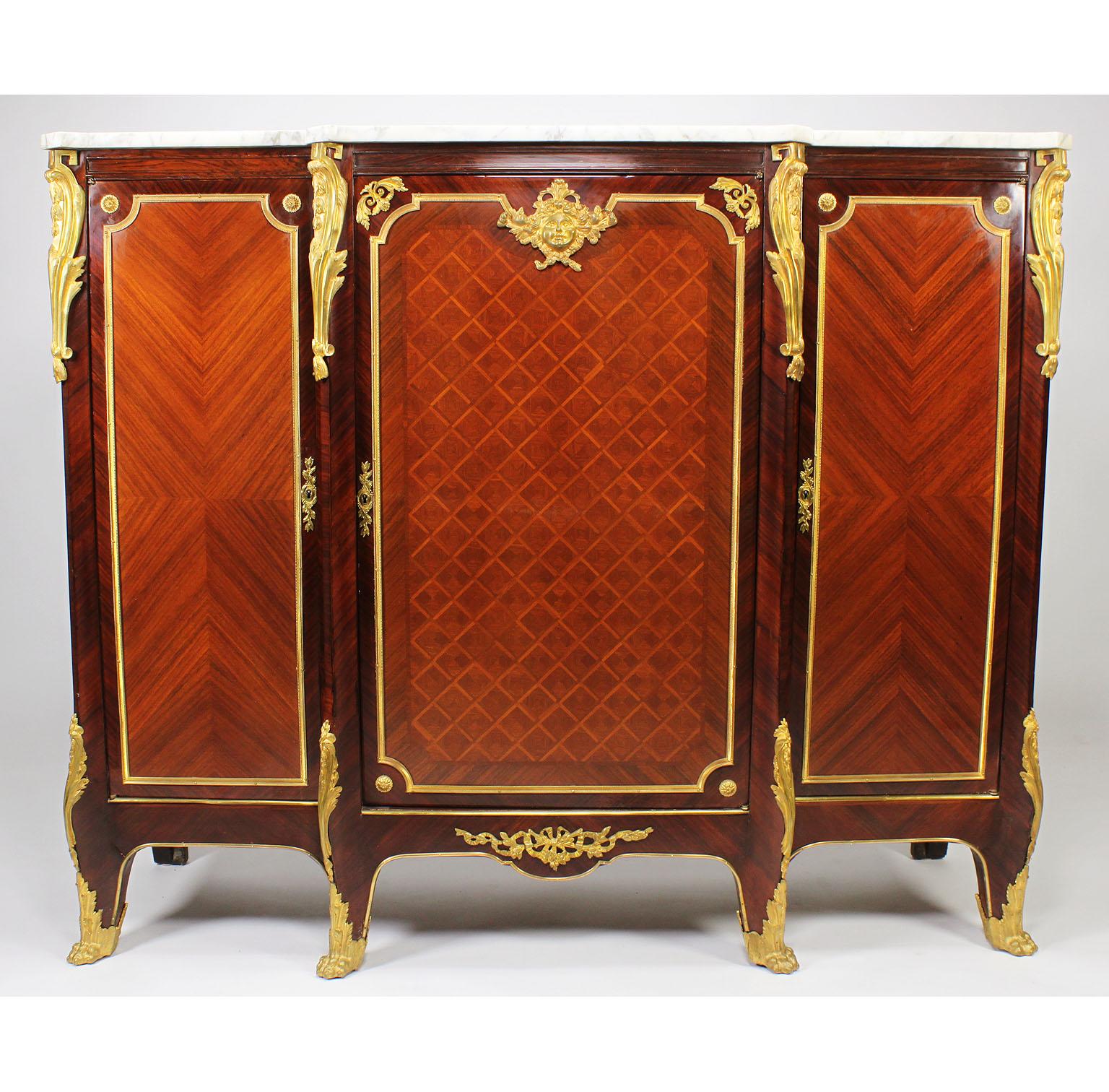 A French 19th-20th century Louis XV style tulipwood parquetry and mahogany gilt-bronze mounted three-door Meuble d' Appui (Side cabinet) with marble top, Paris, circa 1900.

Measures: Height 44 inches (111.8 cm)
Length 53 3/4 inches (136.5