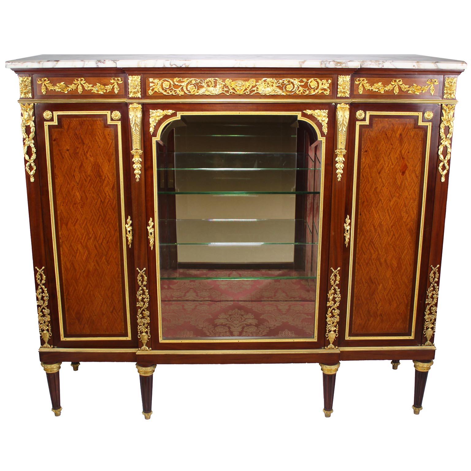 A Very Fine French 19th-20th Century Louis XVI Style Mahogany, Tulipwood and Ormolu-Mounted Parquetry Three-Door Vitrine Commode 'Meuble d'appui with a Brêche Violette Marble Top, attributed to François Linke (1855-1946). The interior of the vitrine