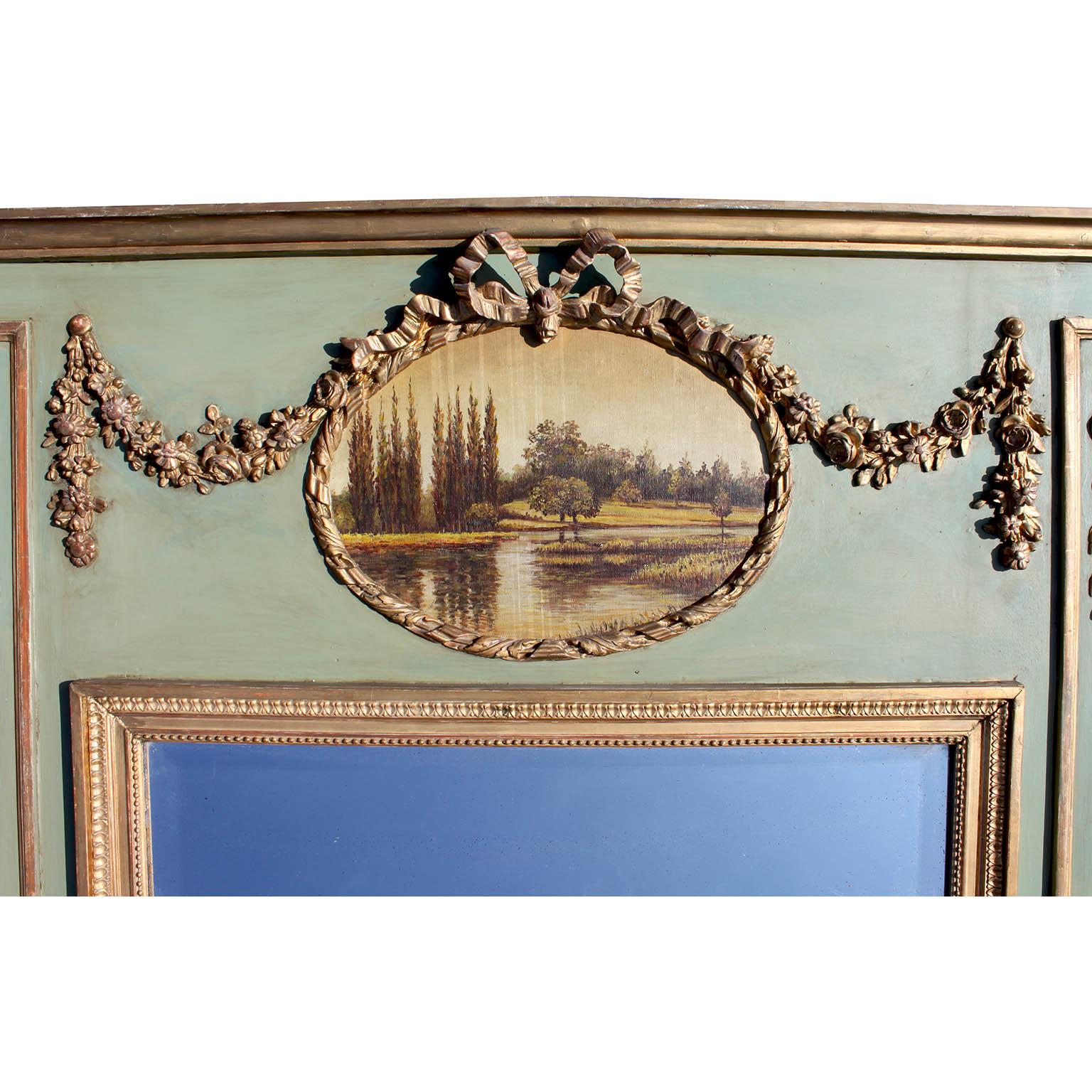 A French Louis XVI Style Belle Époque Trumeau Mirror Frame boasting a rich Verde Green hue accented with delicate parcel-gilt carvings. At its pinnacle rests an oval painting capturing a serene lake-view scene, ensconced within a meticulously carved