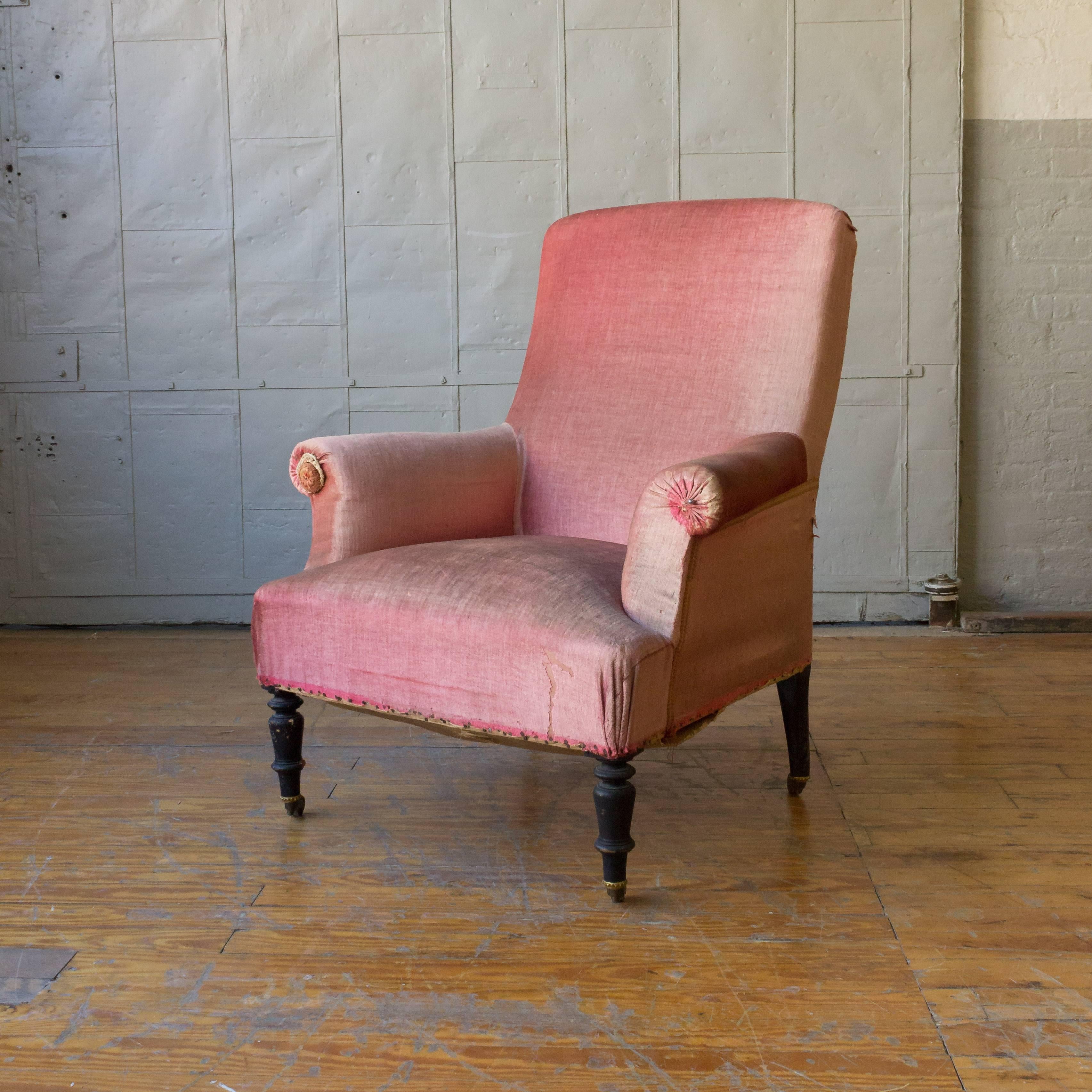 Napoleon III armchair with ottoman, upholstered in coral colored velvet. The chair and ottoman are sold as, upholstery services are available, price on request.

