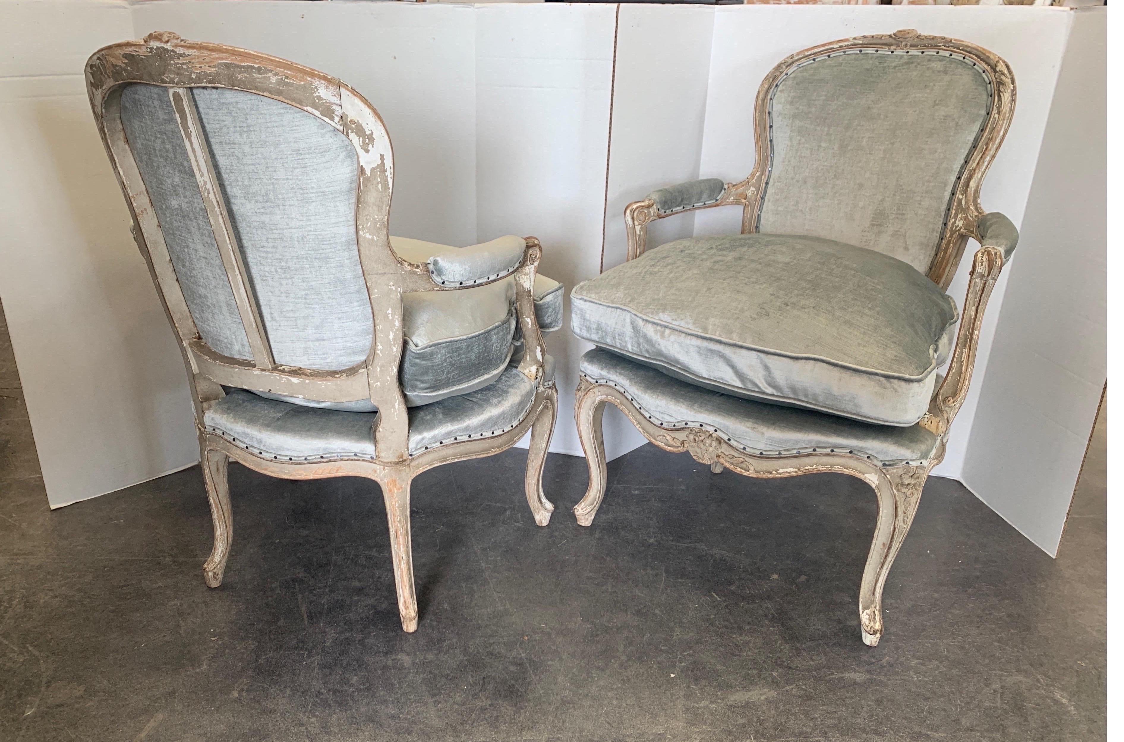 Incredible patina of original paint over blond wood carved chairs. These are after the famous Pierre Nogaret who resided in Paris in the 18th century. They are hand pegged and newly upholstered in nearly the same color as the original mohair was