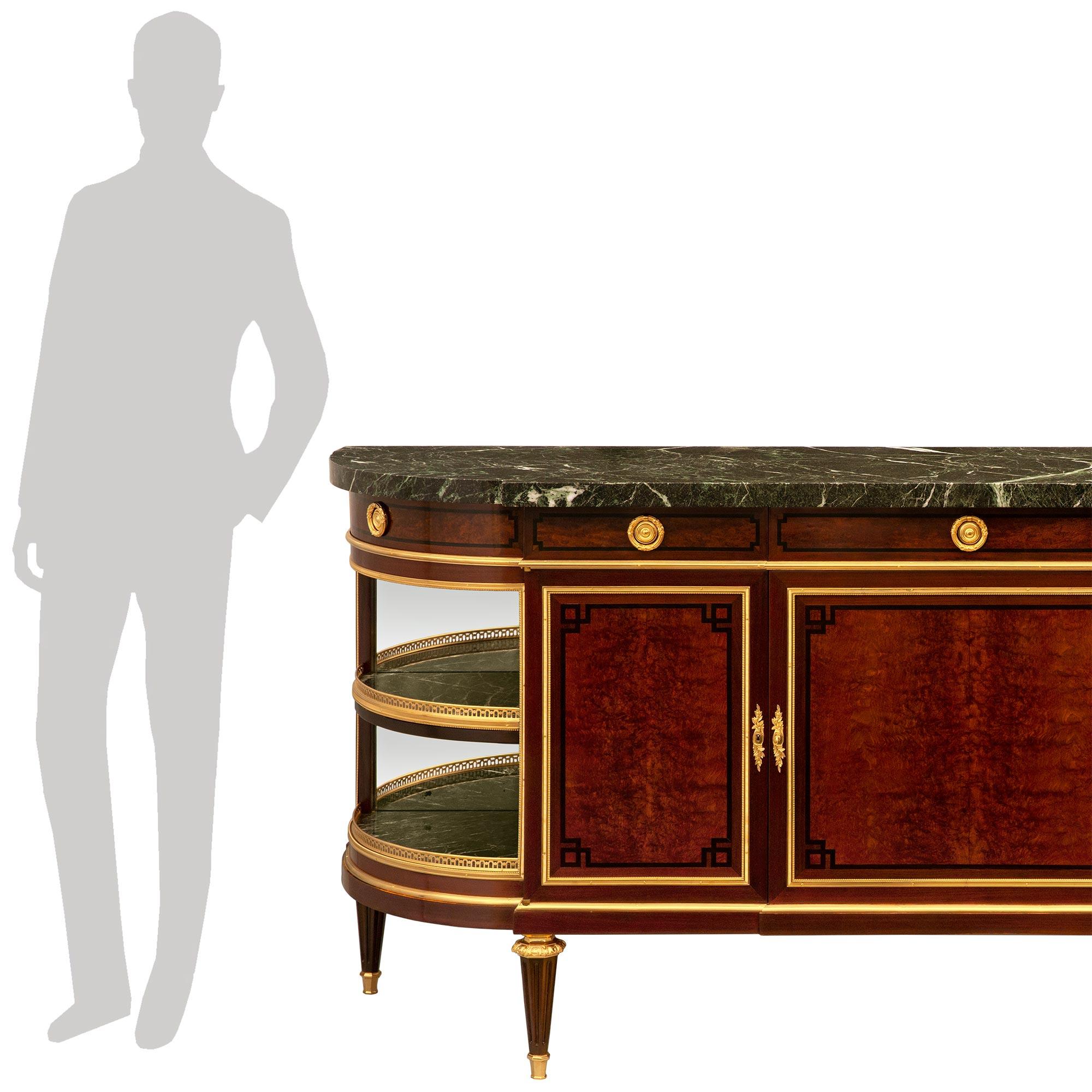 An impressive and most elegant French 19th century Louis XVI st. Mahogany, Carpathian Burl wood, Ormolu and Vert de Patricia marble buffet. This highly detailed buffet is raised on four circular tapered and fluted Mahogany legs with a top octagon