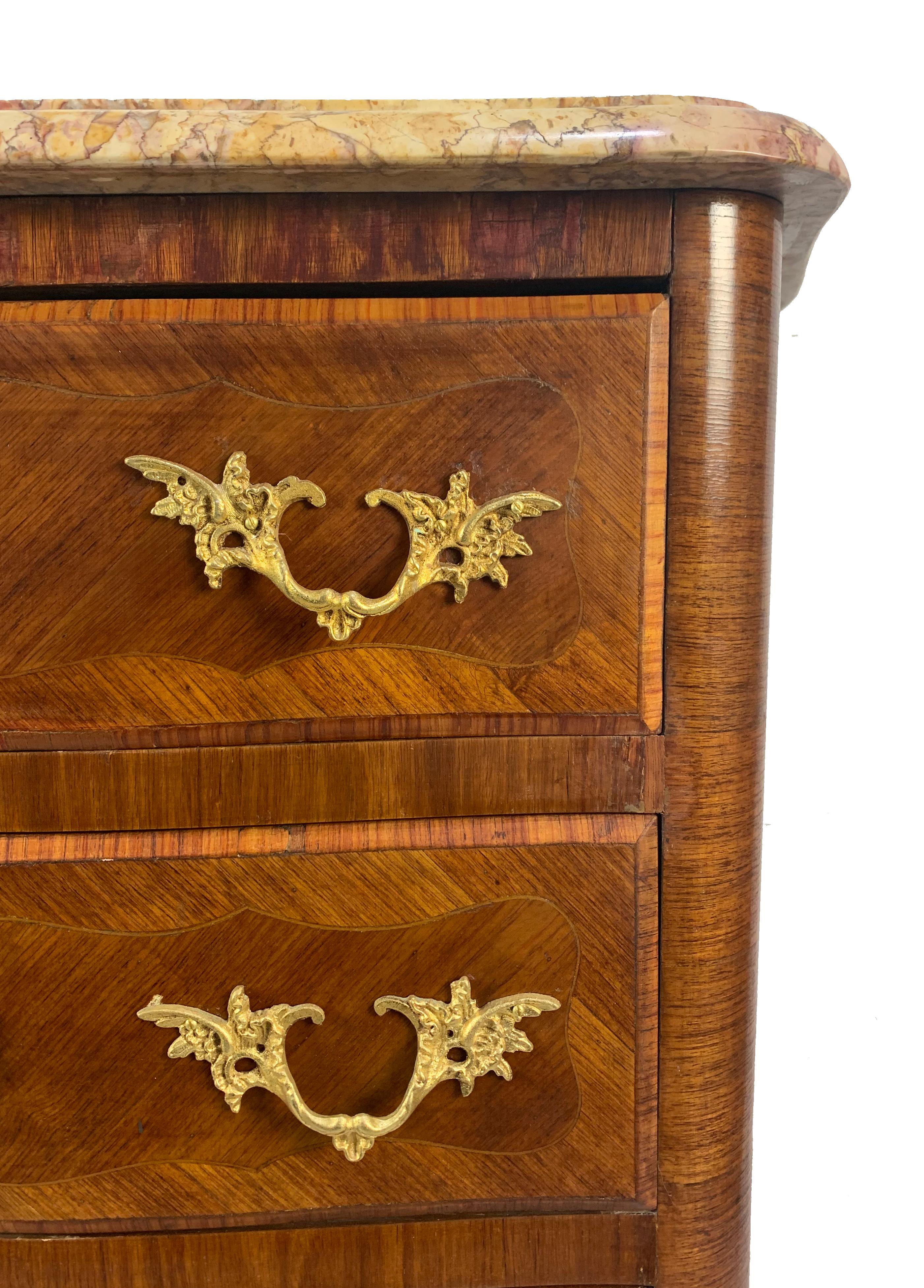 Elegant antique French 19th century Louis XVI style tulipwood chiffonier or lingerie chest with six drawers. Features original marble top and beautiful ornate bronze ormolu mounts and drawer pulls.