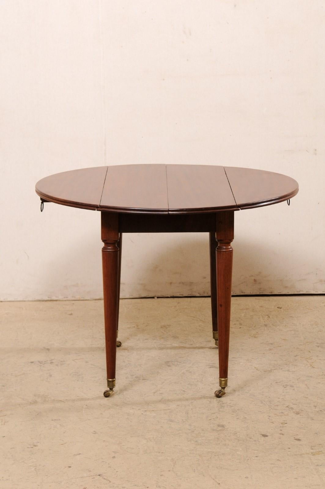 French 19th C. Mahogany Round Table W/Drop Leaves & Petite Brass Caster Feet For Sale 1