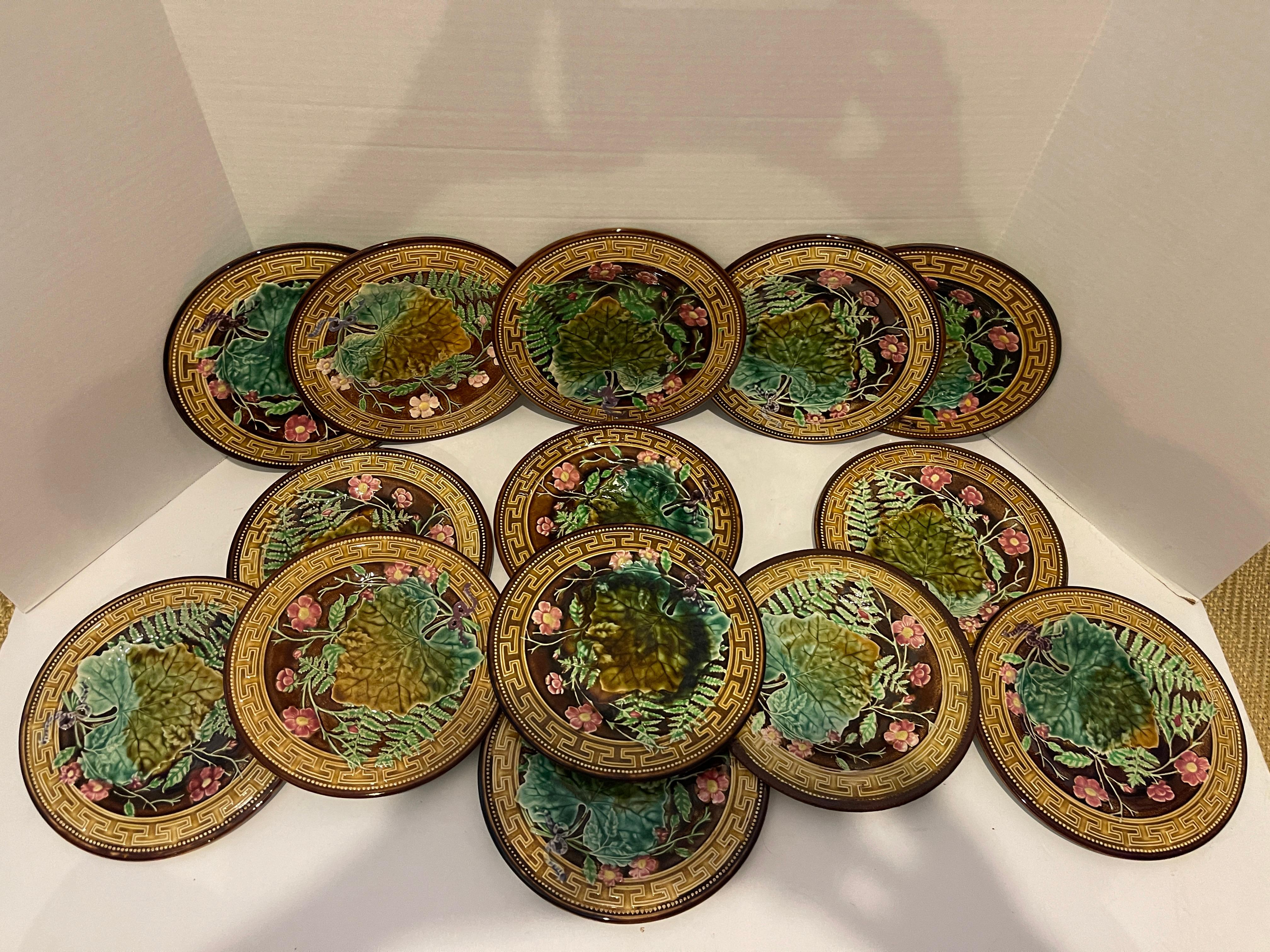 This is a wonderful set and example of beautiful 19th c. French Majolica by the well known manufacture of Choisy le Roi.
This set of French majolica plates with a Greek key border and a Brown beaded rim. 
A central pattern shows overlapping ferns,