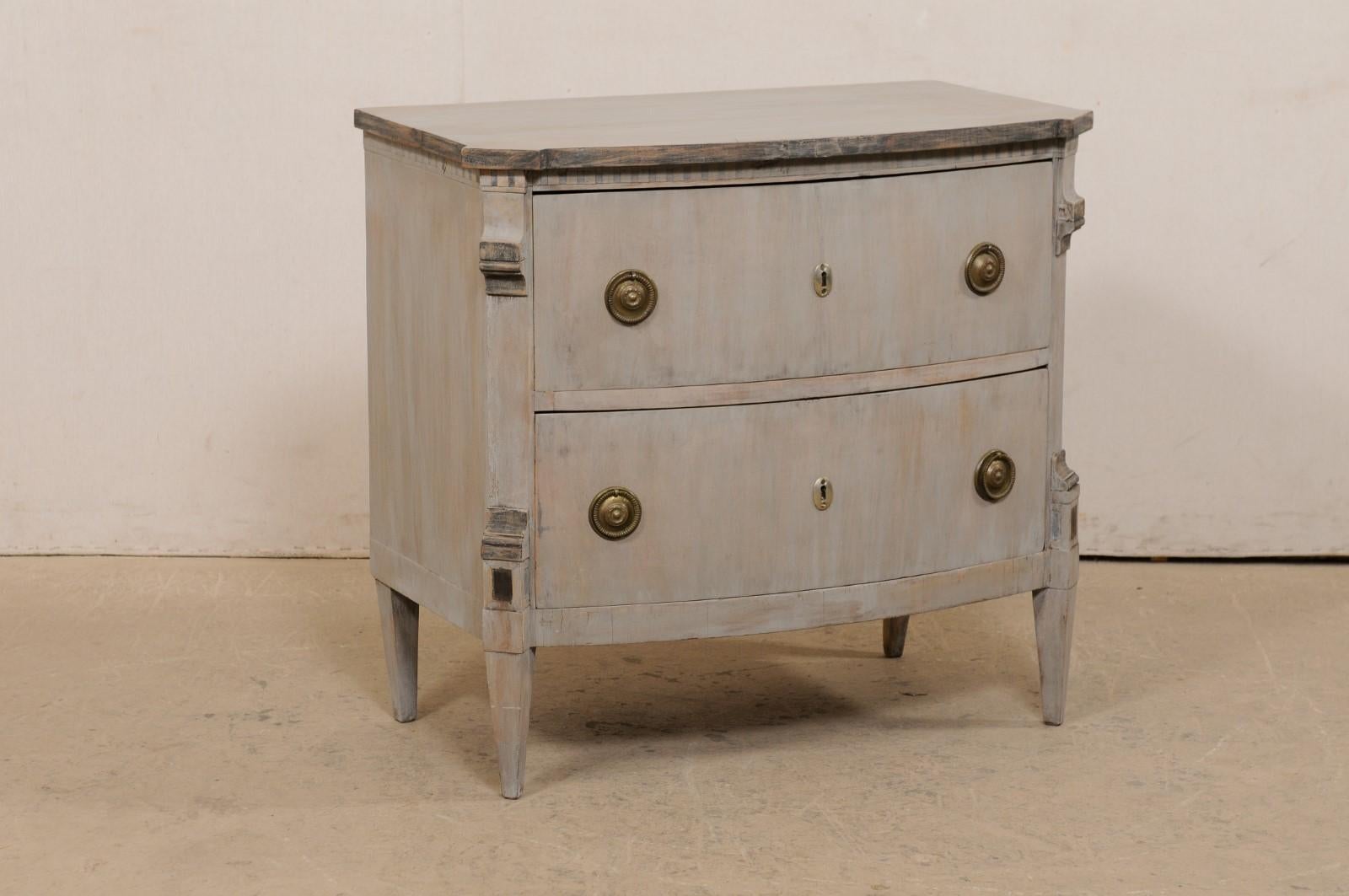 A French raised bow-front chest of drawers from the 19th century. This antique commode from France features a nicely bowed body with top corners having a canted projection, which continues down the carved front side posts an onto the front legs.