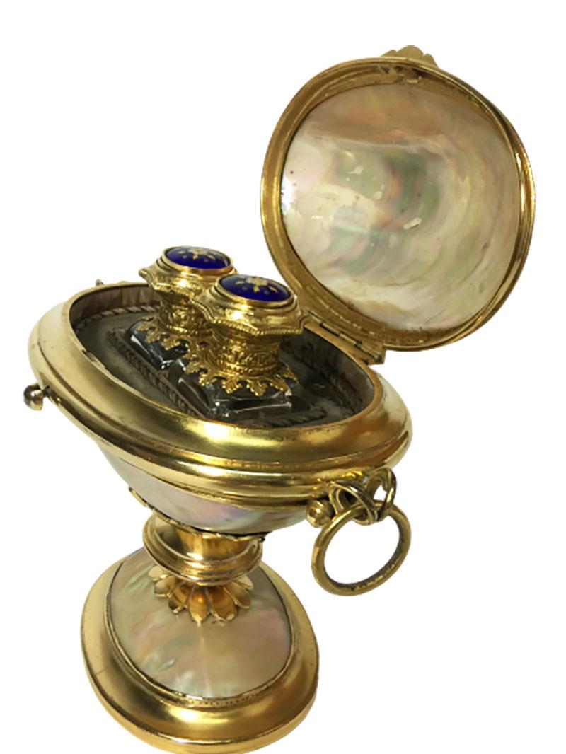 French 19th century Ormolu mother of pearl egg shaped perfume box on foot

A beautiful egg shaped perfume bottle box, with interior of 2 perfume bottles which the lid is enameled and neck in ormolu 
Marked in the rim in front with Songny