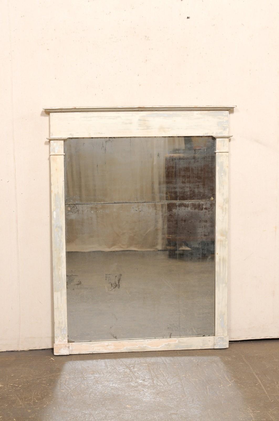 A French painted wood mirror, with its original 2-piece glass, from the 19th century. This antique mirror from France features a rectangular-shaped frame with clean lines accented with a molded top rail, and side surrounds having trim embellishments