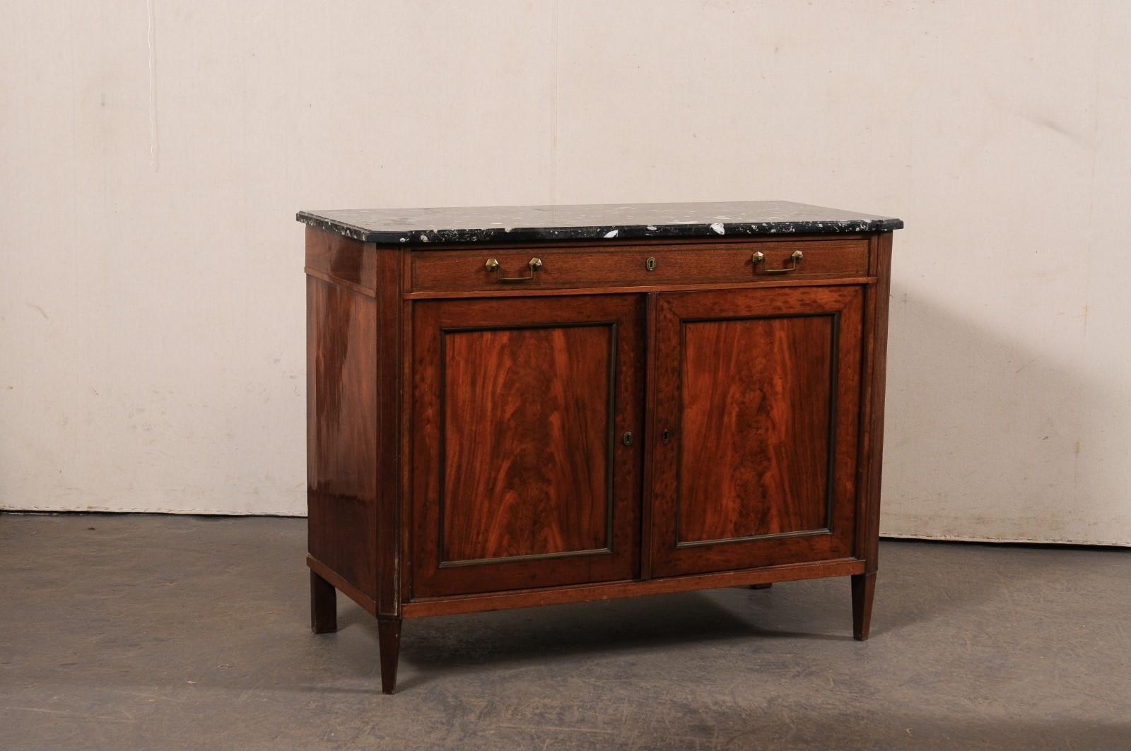 A French wooden buffet console, with really nice marble top, from the 19th century. This antique chest from France (just over four feet in length) features a rectangular-shaped black marble top with pronounced and canted front corners, which rests