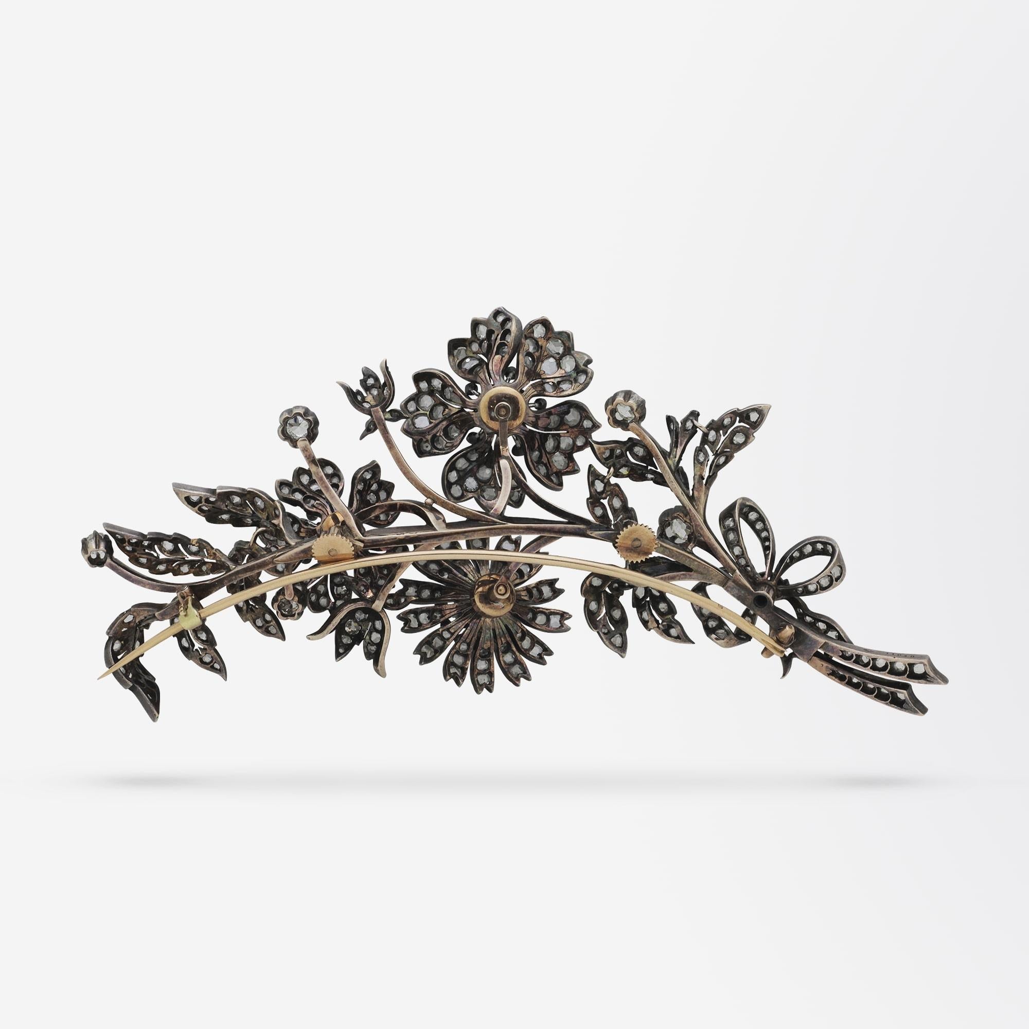 An exceptional French, floral spray 'en tremblant' brooch pin. This 18 karat gold piece comprises of several components which screw together to form one large brooch. The piece can be pulled apart to create a smaller spray, likely used as a hair