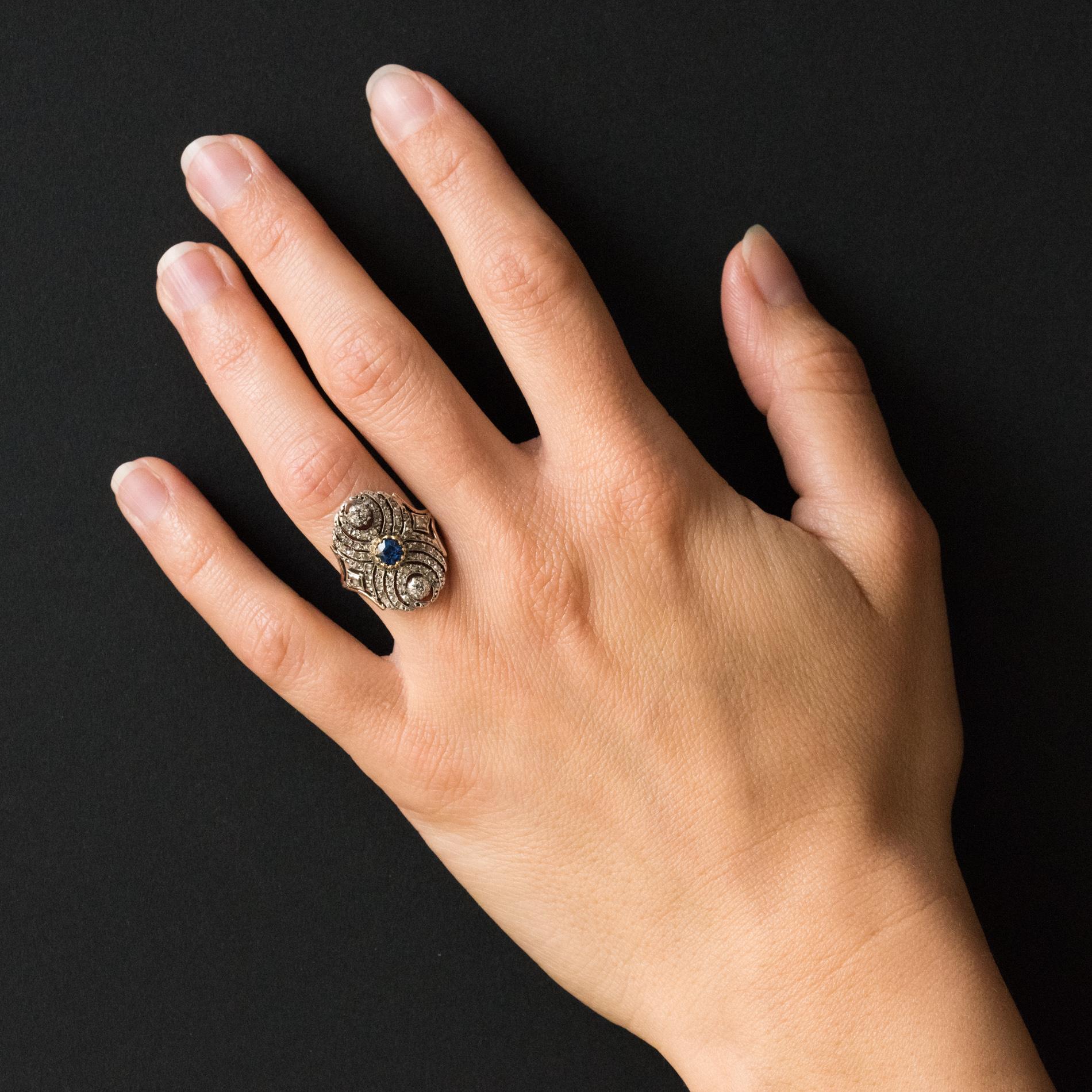 Ring in 18 Karats rose gold ring, eagle's head hallmark and silver.
Lovely antique ring, it is set in the center with lowered claws of a cushion-cut sapphire and 2 antique brilliant-cut diamonds also with lowered claws. The whole openwork tray is