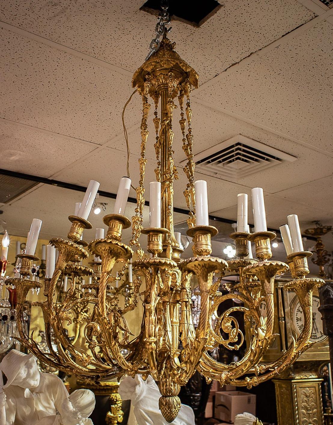 19th century French gilt bronze chandelier in the Louis XVI style with 18 electrified candles, ready for use.