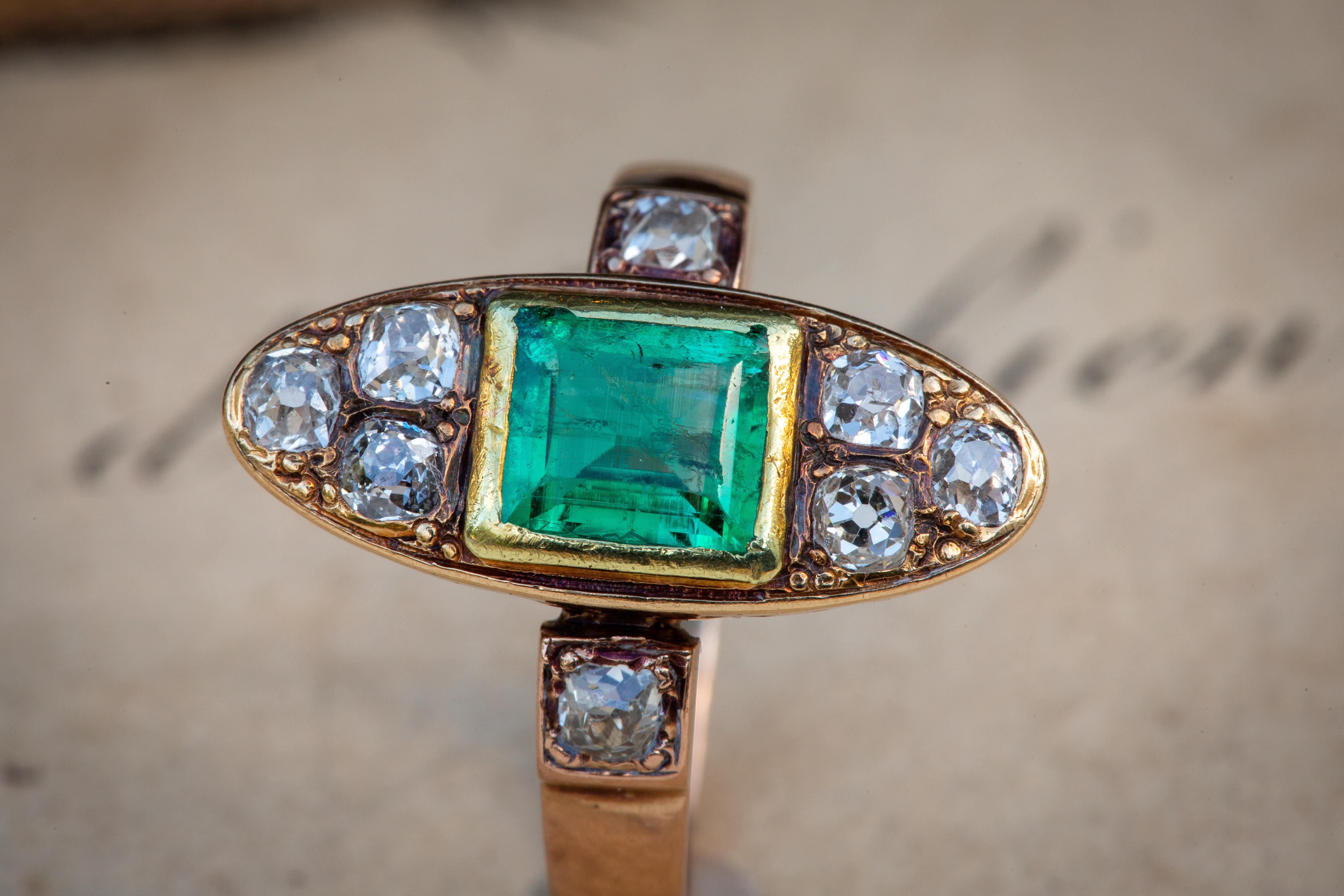 This stunning navette-shaped French gold ring dates to the second half of the 19th century. In the centre rests a rub-over bezel set and open-back natural emerald with a fantastic hue and saturation. It weighs approximately 0.7ct and is likely to be