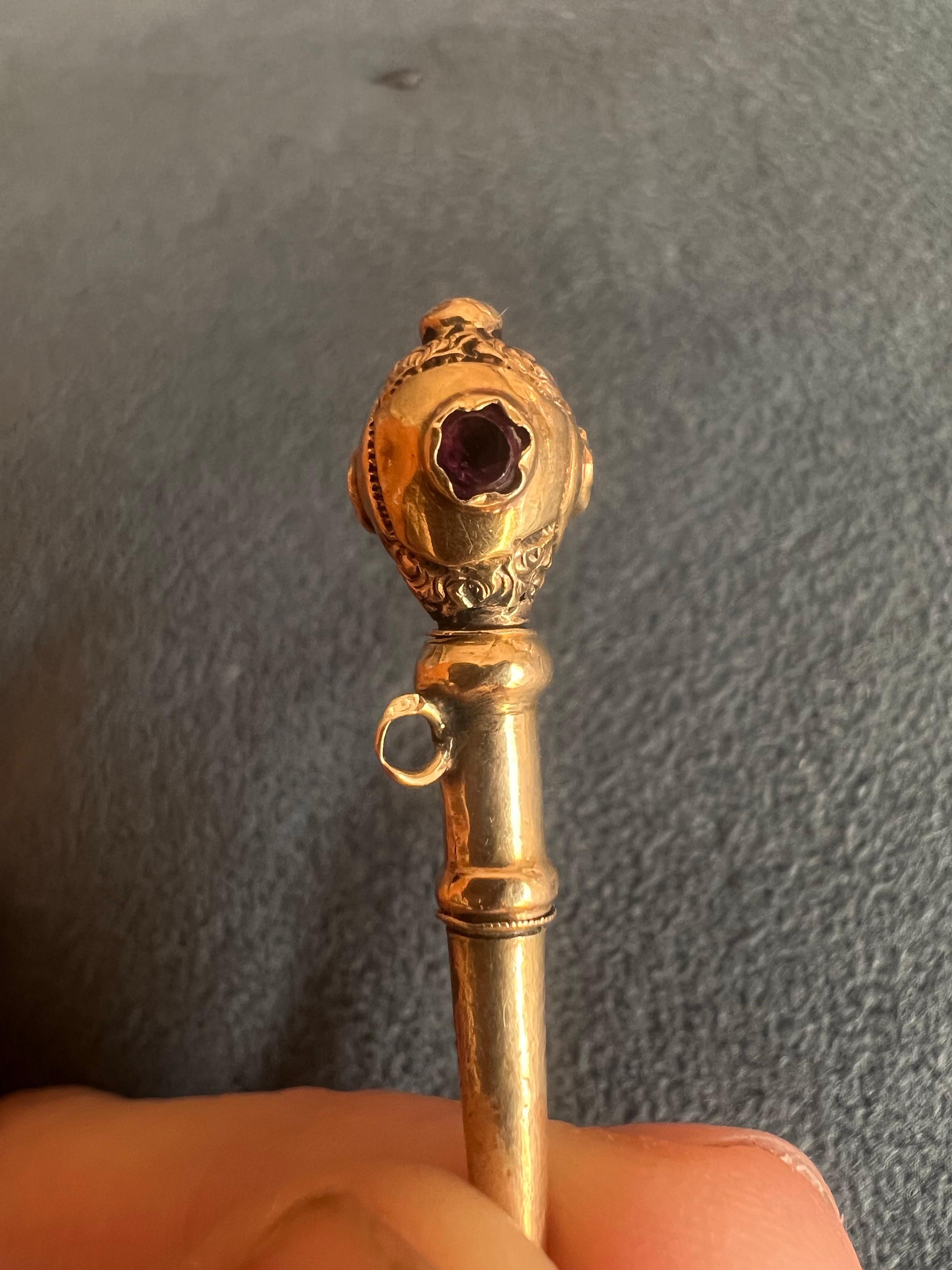 French golden engraved pocket watch key that would look great even just as a pendant on a proper chain. It has delicate engravings on the top and three surrounded small ruby stones that gives it a jewellery vibes. It is in original authentic