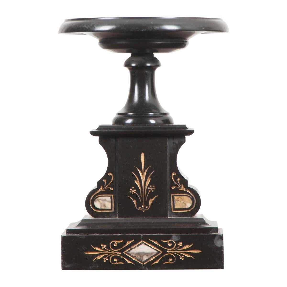 This handsome three-piece black marble clock garniture, in the Aesthetic taste, is from France, circa 1860s. Consisting of a gilt-incised and rouge-and-grey marble inset clock with gilt-brass bezel, enameled dial, and hand painted Roman numerals,