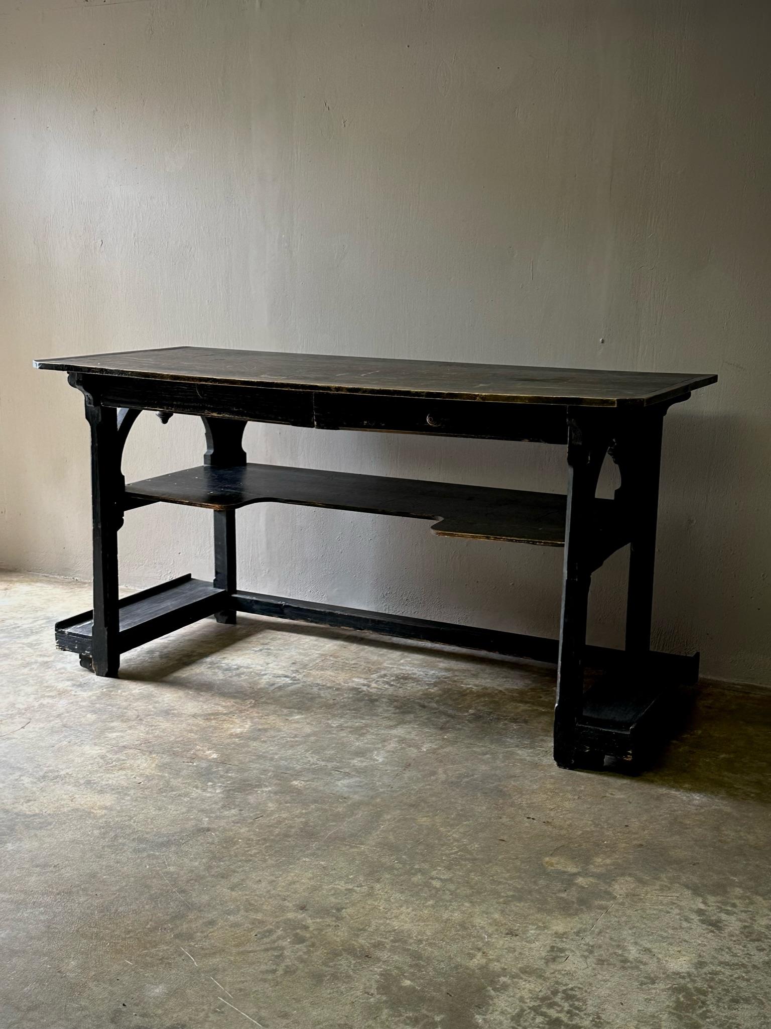 French 19th century ebonized wood architect's desk. Features elegant utilitarian lines and exquisite hand-carved detail work. With its dark, rich patina and versatile proportions, this transitional piece would work in a variety of settings.