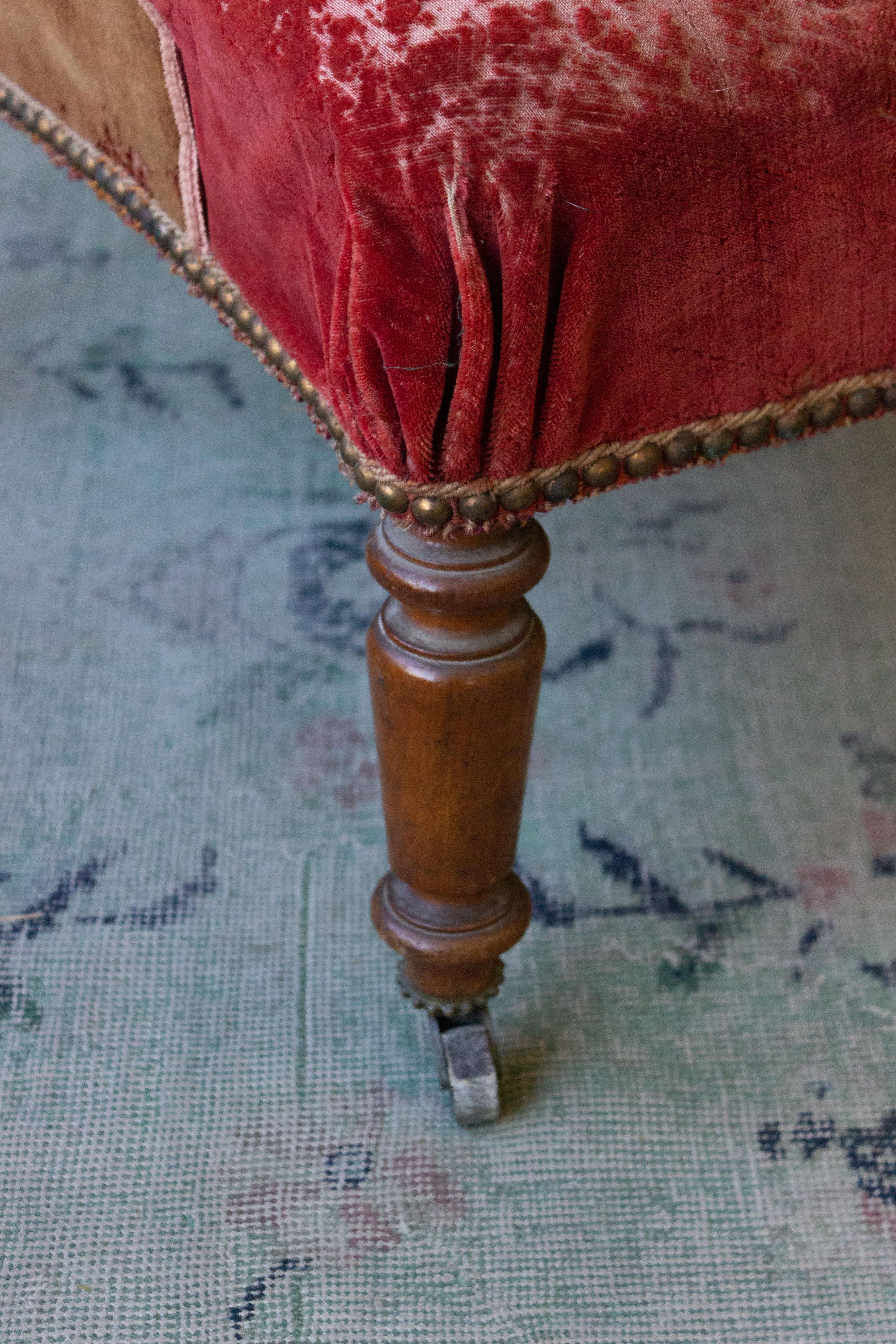 Napoleon III armchair with a scrolled back with original and distressed red velvet.