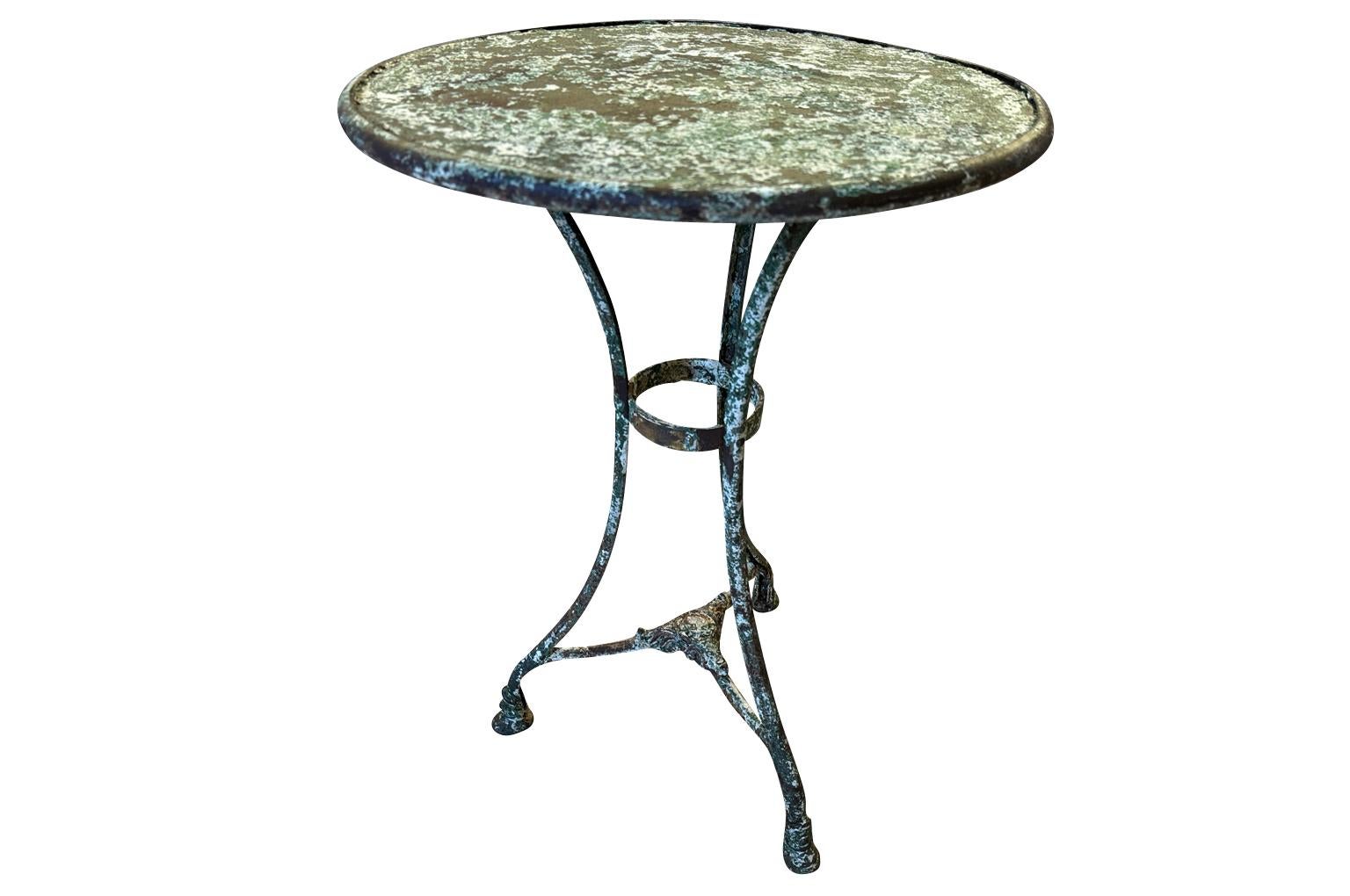 A delightful 19th century Garden Gueridon - Bistro Table from Arras, France. Wonderfully constructed from hand forged iron with its manufacturer's plaque from Saint Sauveur. Fabulous patina. Perfect for any interior of garden. 