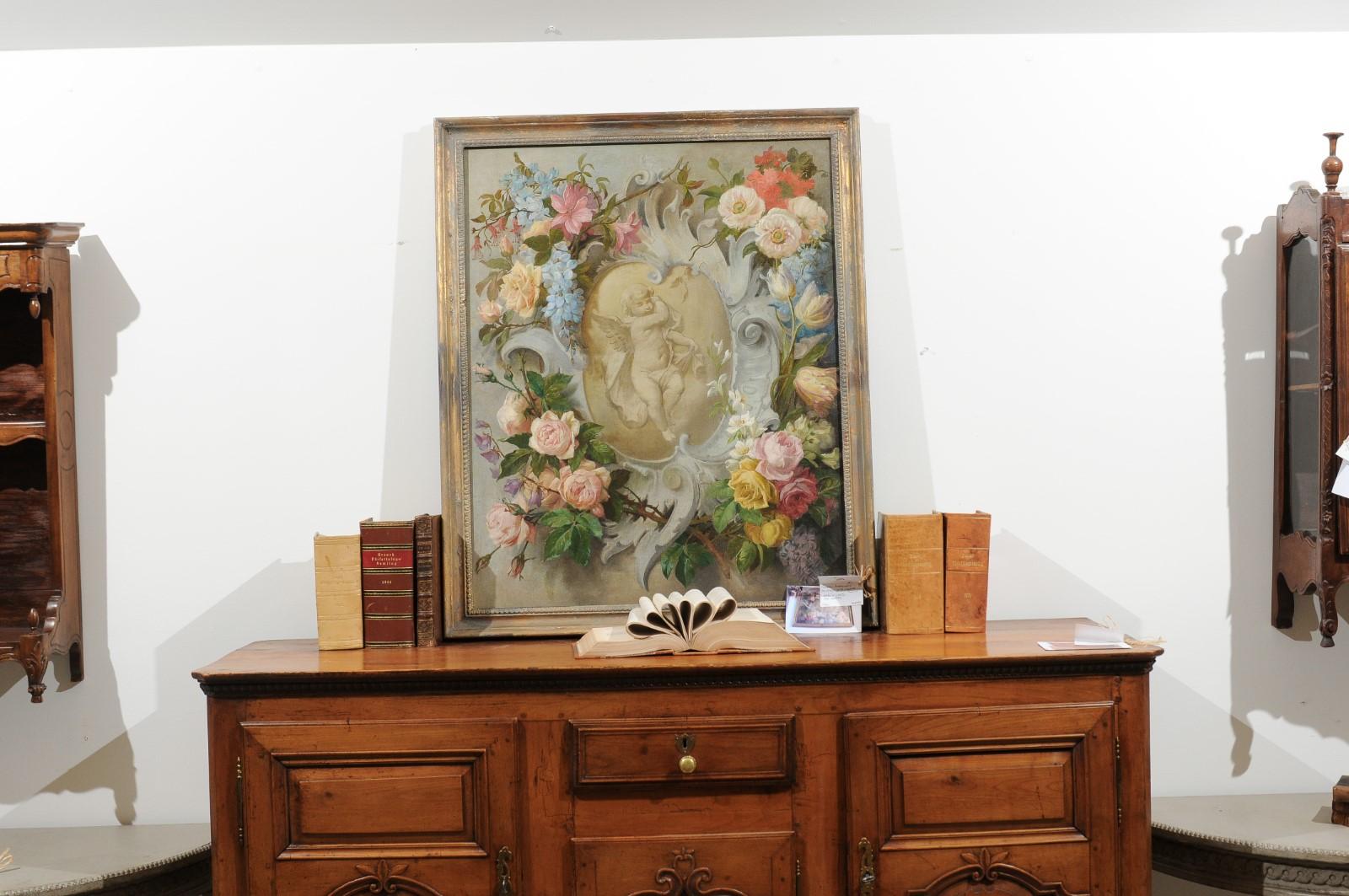 A French Aubusson cartoon painting from the 19th century, with floral decor surrounding a cherub populated cartouche. Created to be used as a model to weave a tapestry in the Aubusson manufacture located in central France, this framed oil painting
