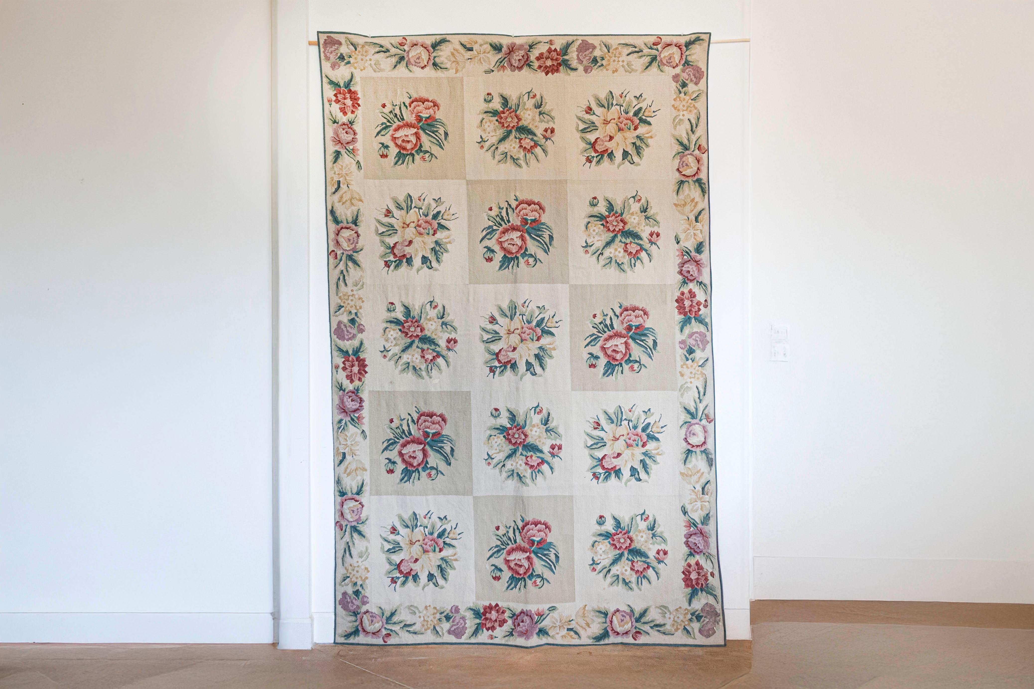 A French Aubusson wall tapestry from the 19th century, with pink and cream floral décor. Created during the 19th century in the Aubusson manufacture located in central France, this wall tapestry features a perfectly organized décor showcasing