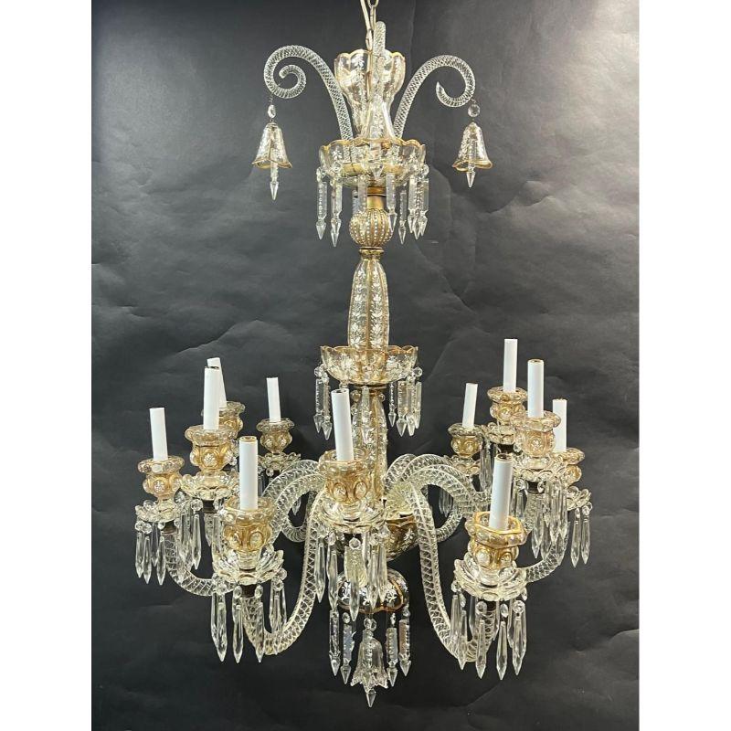 Stunning French 19th century Baccarat glass chandelier consisting of 12 detailed glass branches with candelabra sockets resting on alluring candle bebeches. Beautiful detailedly painted flowers on the glass pieces. This piece does not include a