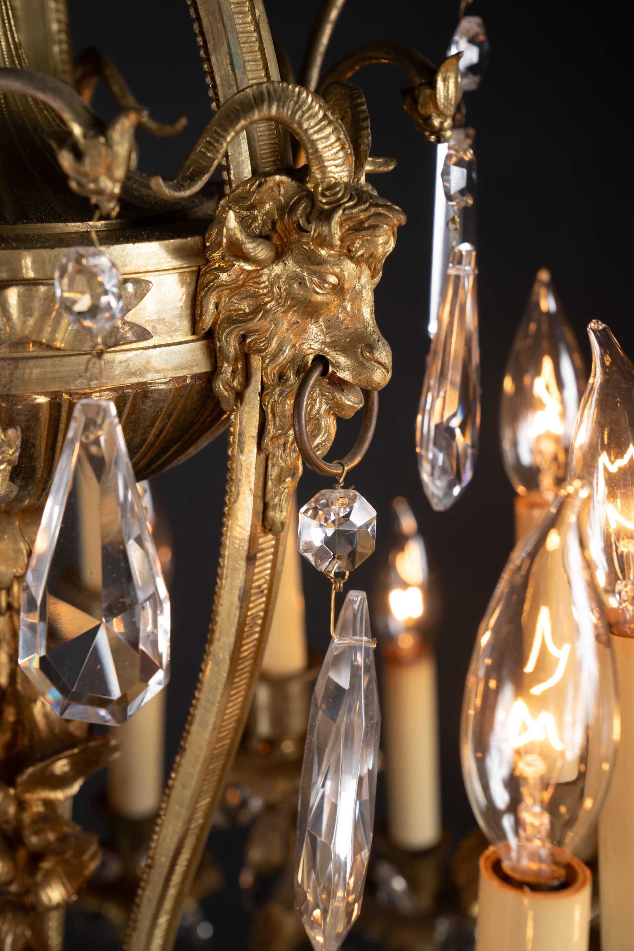 This majestic Napoleon III finely chiseled ormolu chandelier  is exquisite. The French antique piece dates back to the 19th century, and features a plethora of magnificent details.  Beginning at the top, we see a crown sporting acanthus leaves on