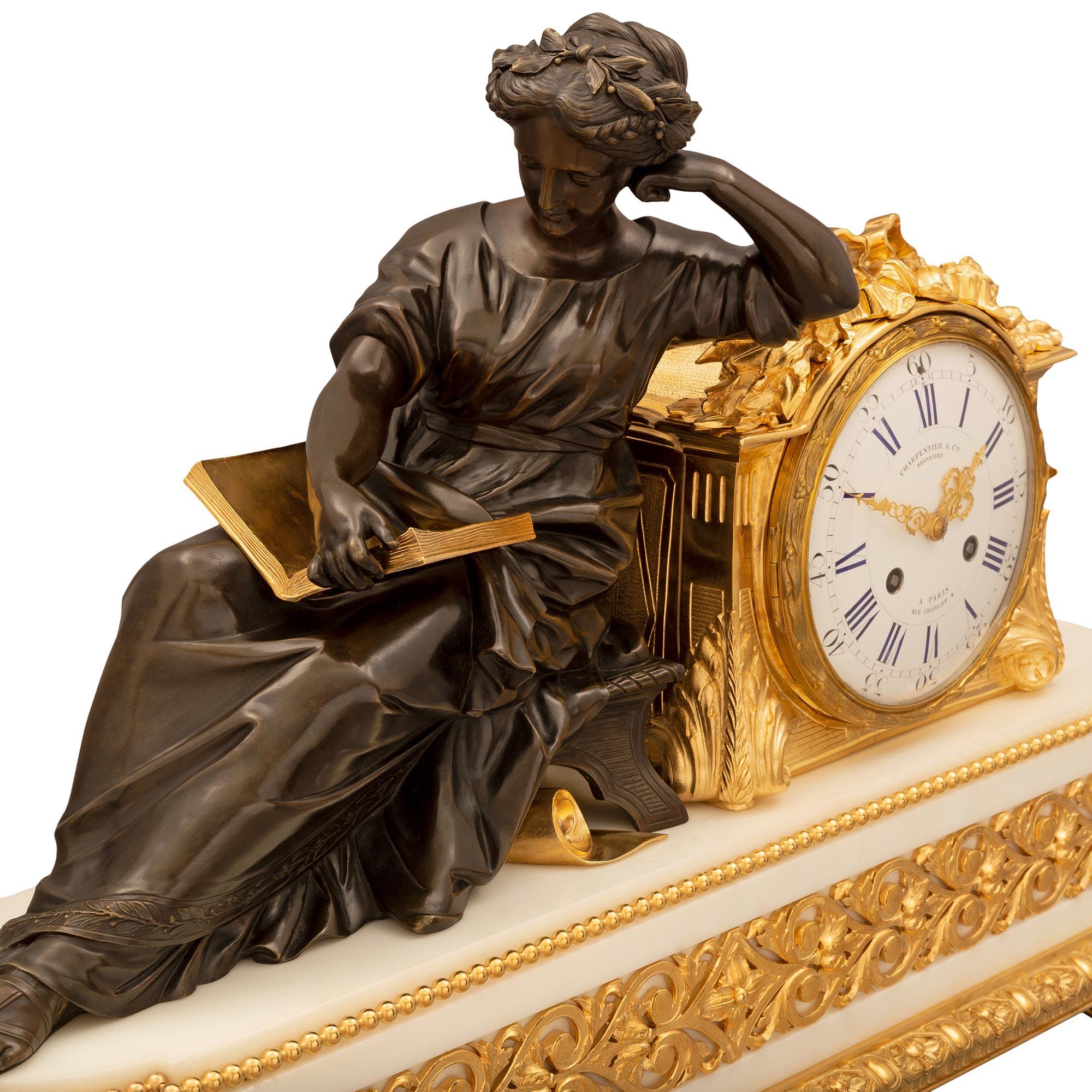 A stunning and extremely high quality French 19th century Louis XVI st. Belle Époque period ormolu, patinated bronze and white Carrara marble clock by Charpentier & Cie. The clock is raised by six elegant topie shaped feet below a lovely and most