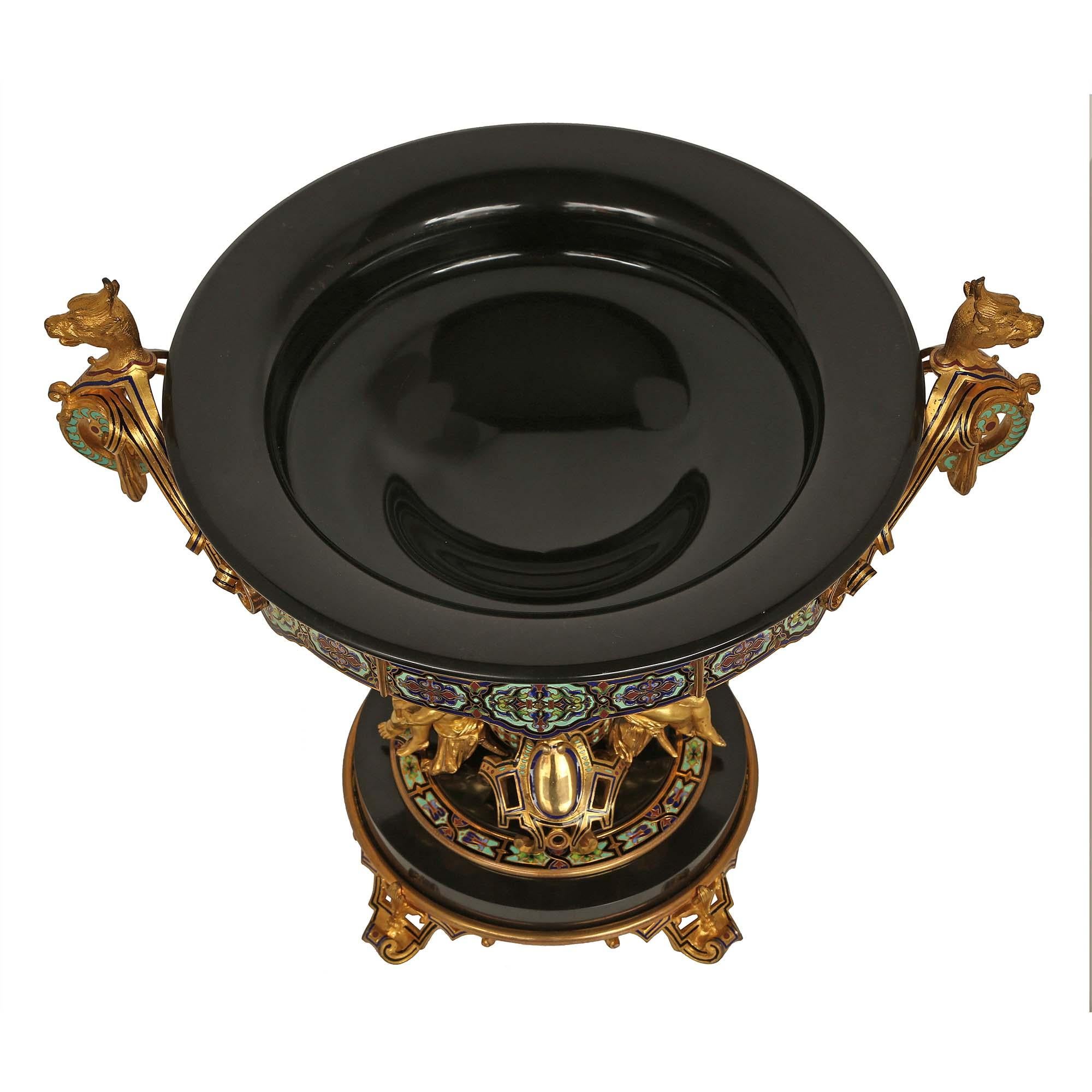 An important and most impressive French 19th century Belle Époque Period black Belgian marble, ormolu and cloisonné signed centerpiece. The striking and large scale centerpiece is raised by four pierced ormolu scrolled feet each decorated with a