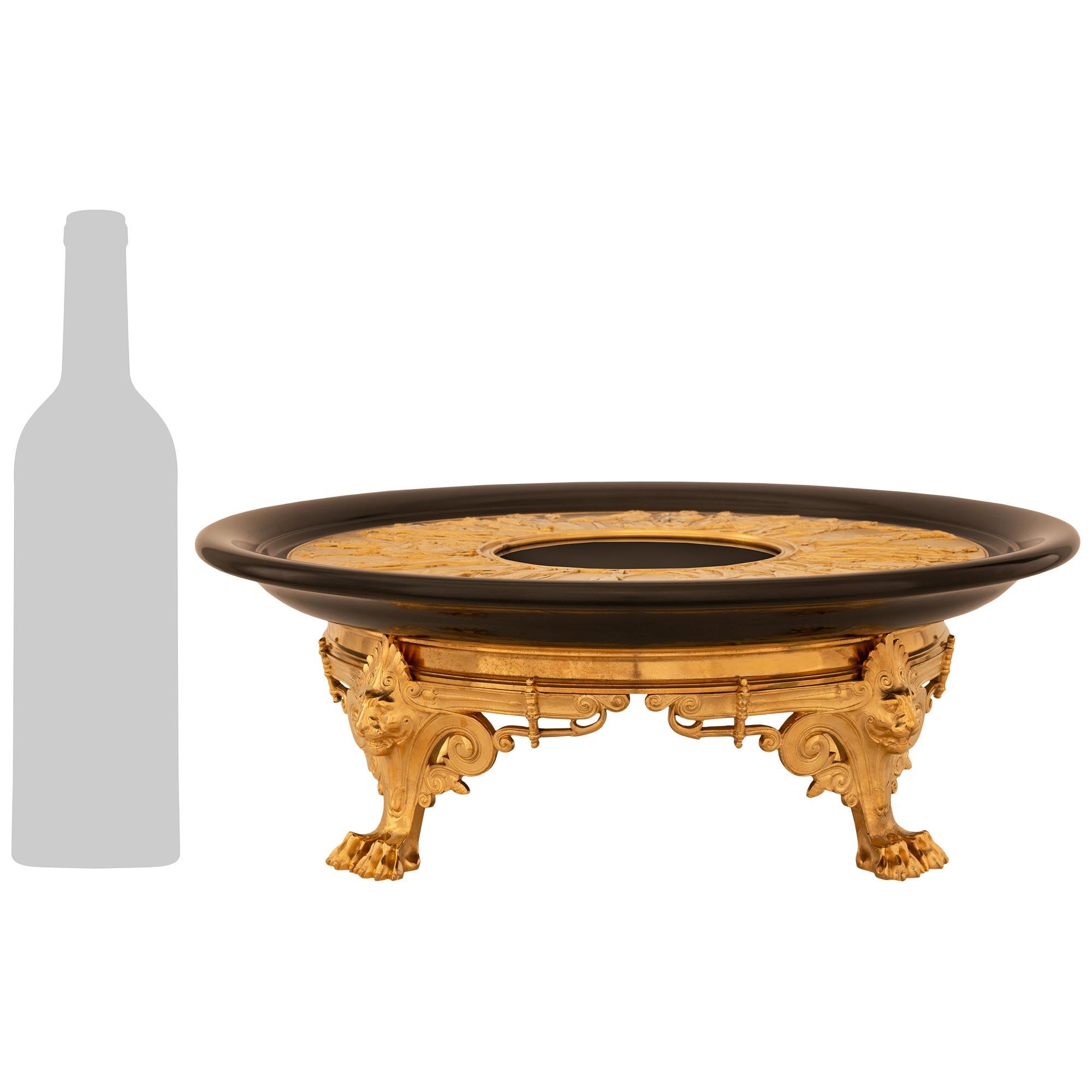 A handsome and most decorative French 19th century Belle Époque period Neo-Grec st. black Belgian Marble and Ormolu centerpiece, attributed to F. Barbedienne. This exceptional circular centerpiece is raised by four scrolling decorated legs with a