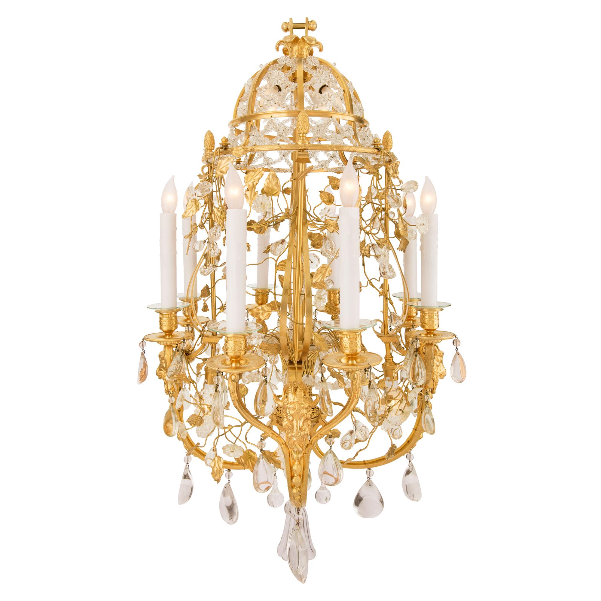 A sensational and most unique French 19th century Louis XVI st. Belle Époque period ormolu and Baccarat crystal birdcage shaped chandelier. The charming eight arm twelve light chandelier is centered by a beautiful bottom tulip shaped Baccarat