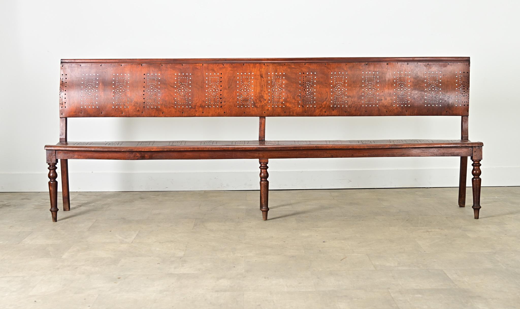 This striking late 1800s French walnut bentwood and turned-leg armless hall bench, easily seating four to five guests, reflects an innovative period for woodcraft in the 19th century to meet increasing demands of an upwardly mobile society while