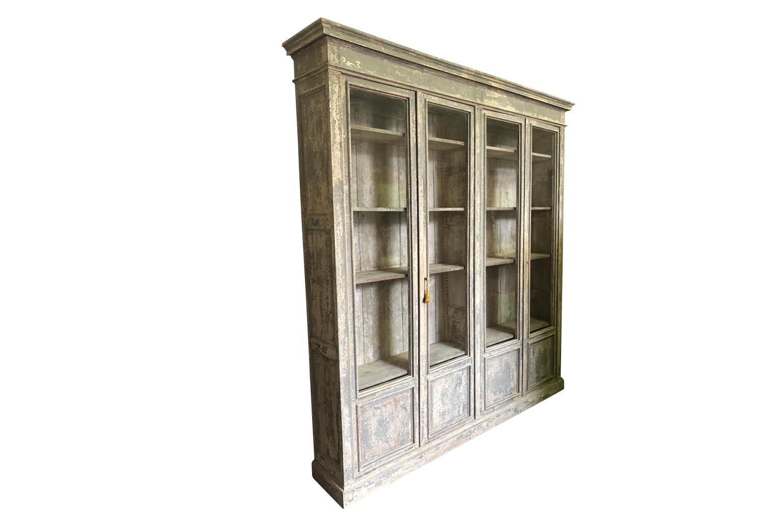 A very handsome 19th century Bibliotheque from Provence region of France. Wonderfully constructed from painted wood with 4 doors on a plinth base. A terrific display and storage piece.